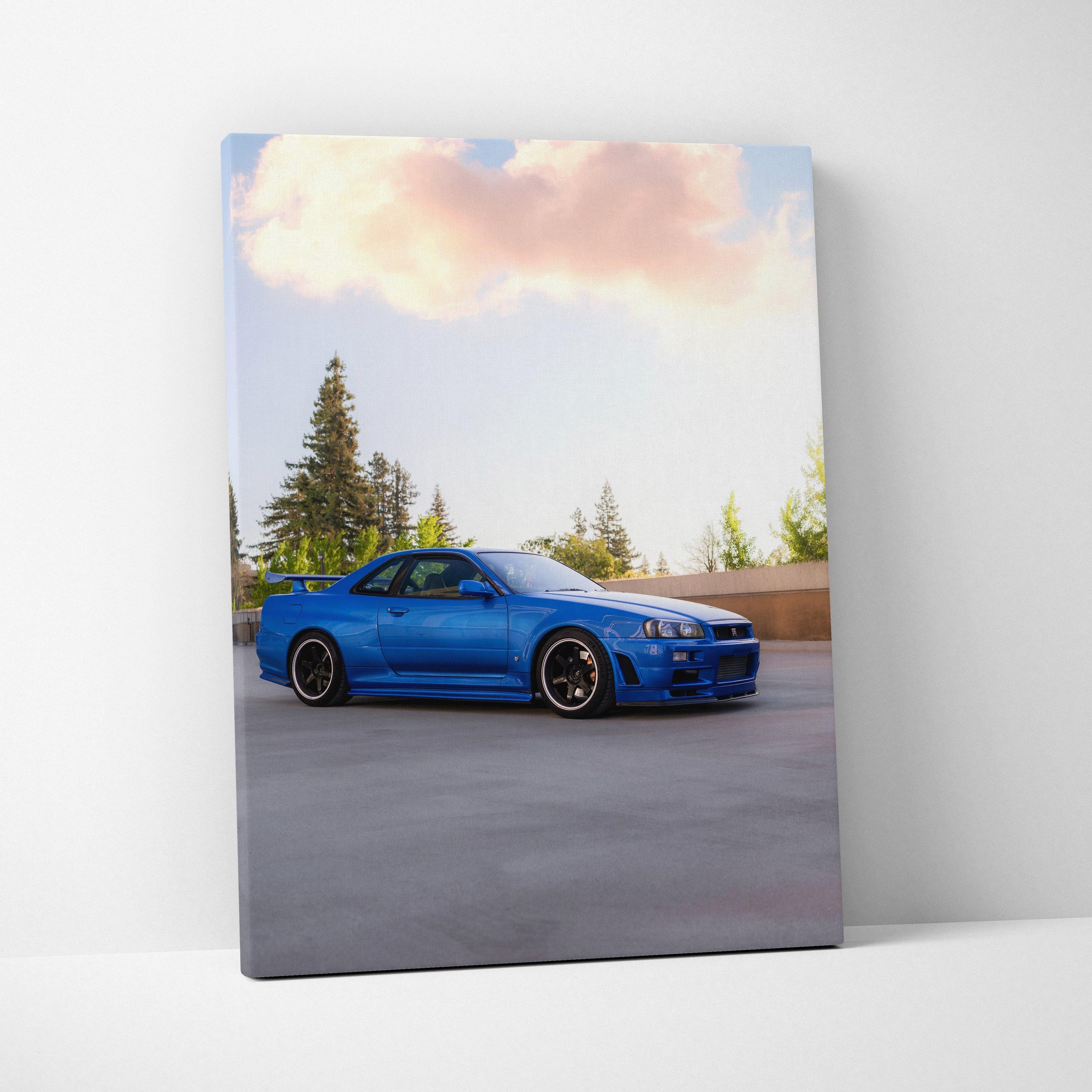Blue Nissan R34 GTR sports car on vertical canvas wall art with soft sky background.