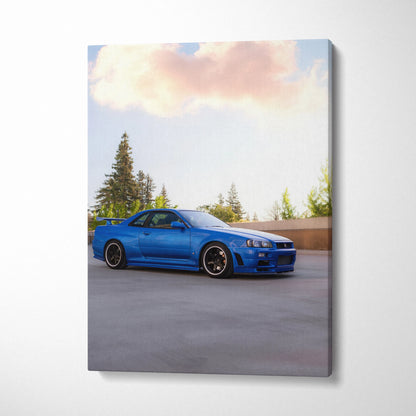 Blue Nissan R34 GTR sports car on canvas wall art with soft sky and trees background.