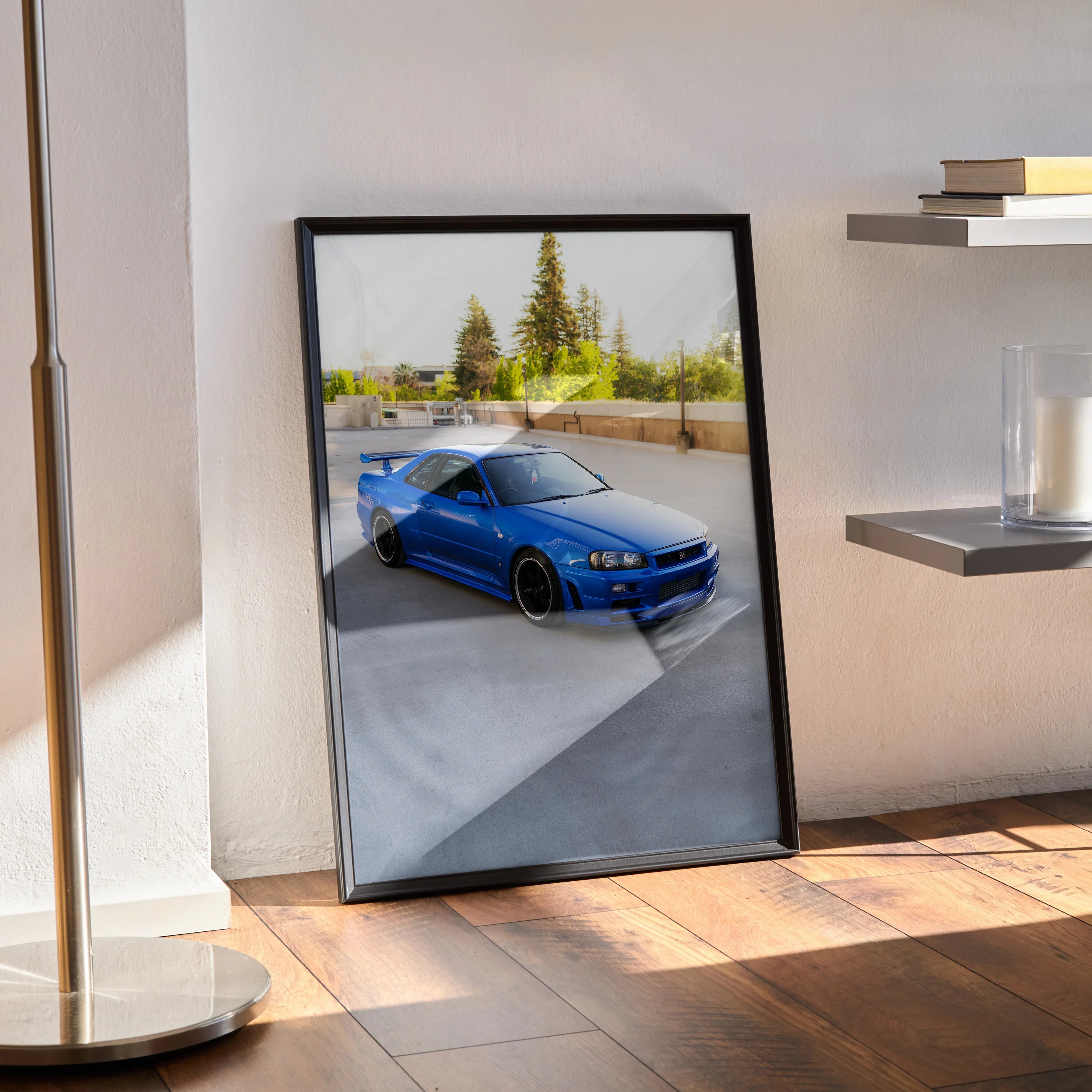 Nissan R34 GTR Skyline poster wall art with blue car parked outdoors framed in black.