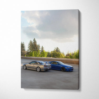 Vertical canvas art featuring Nissan R34 GTRs in silver and blue parked on open road under cloudy sky.