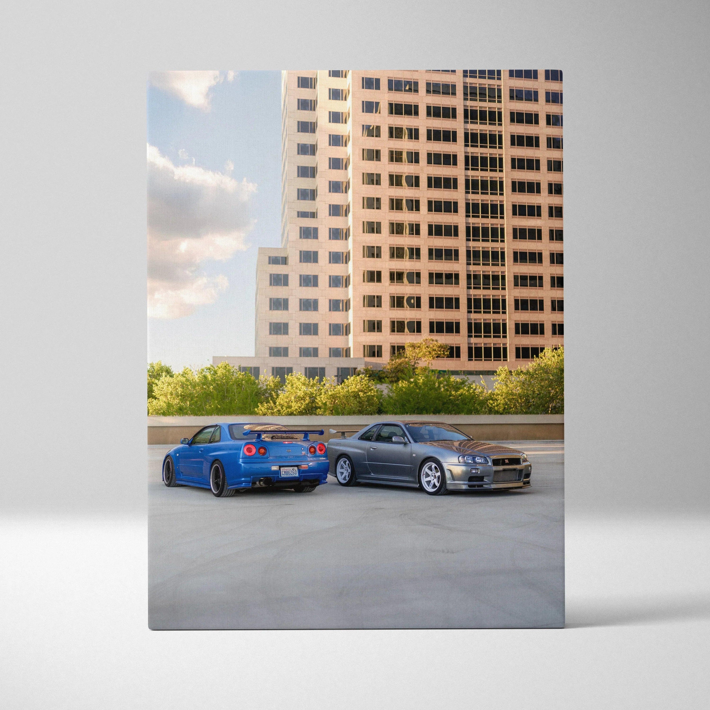 Nissan R34 GTR blue and silver cars parked with cityscape background vertical canvas wall art.
