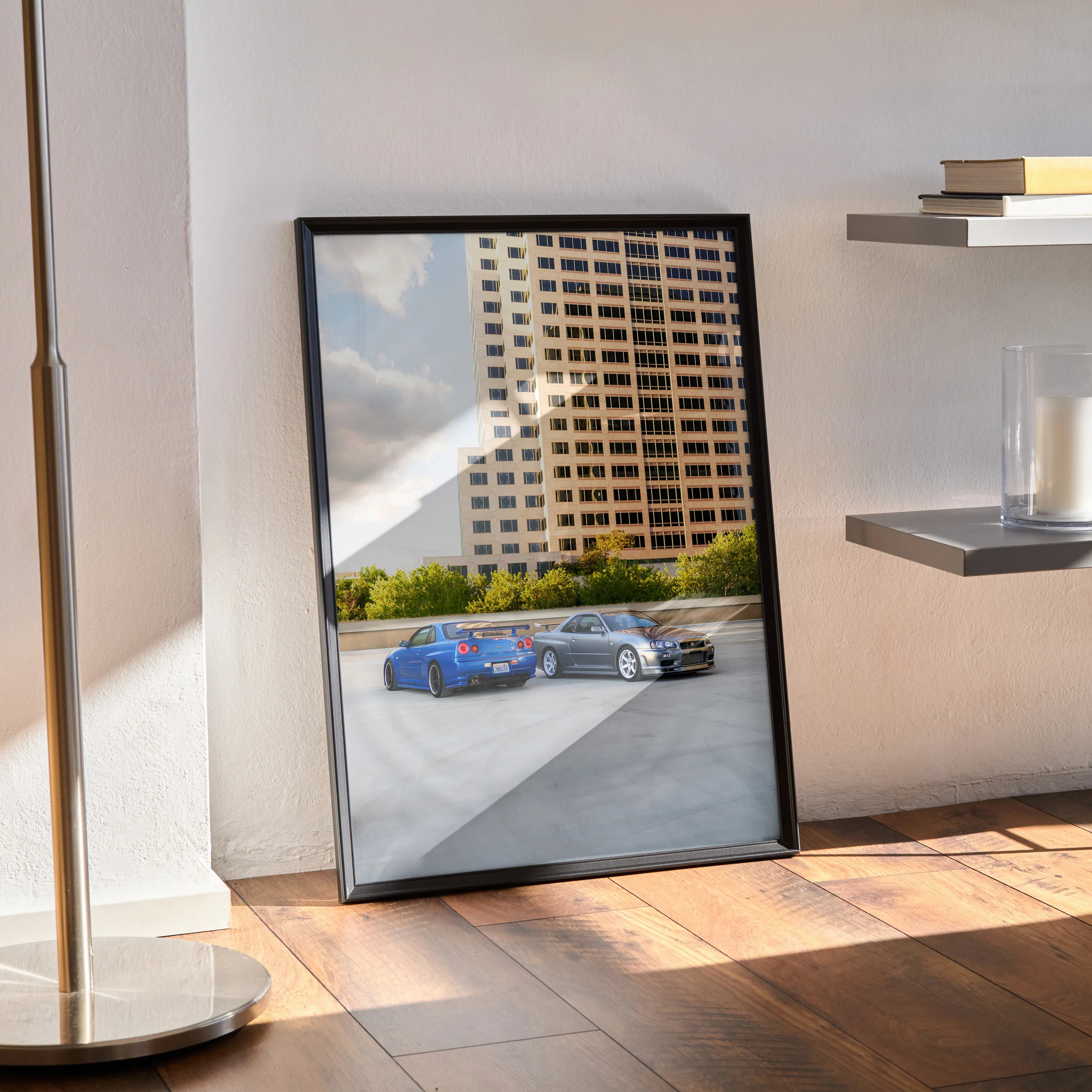 Nissan R34 GTR Skyline poster wall art with cityscape and parked cars in daylight.