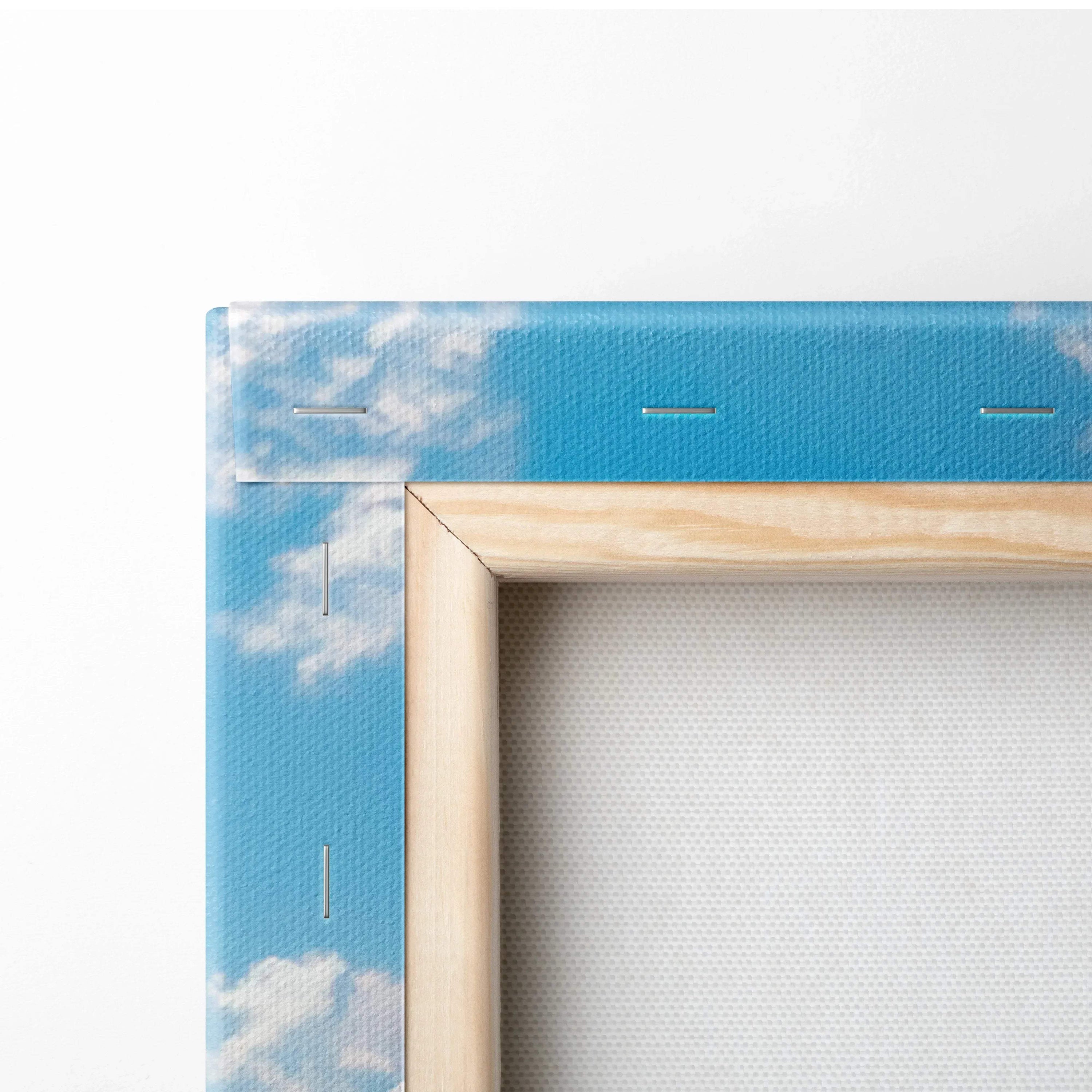 Close-up of stretched canvas corner with blue sky and white clouds printed, wooden frame visible, vertical wall art canvas.
