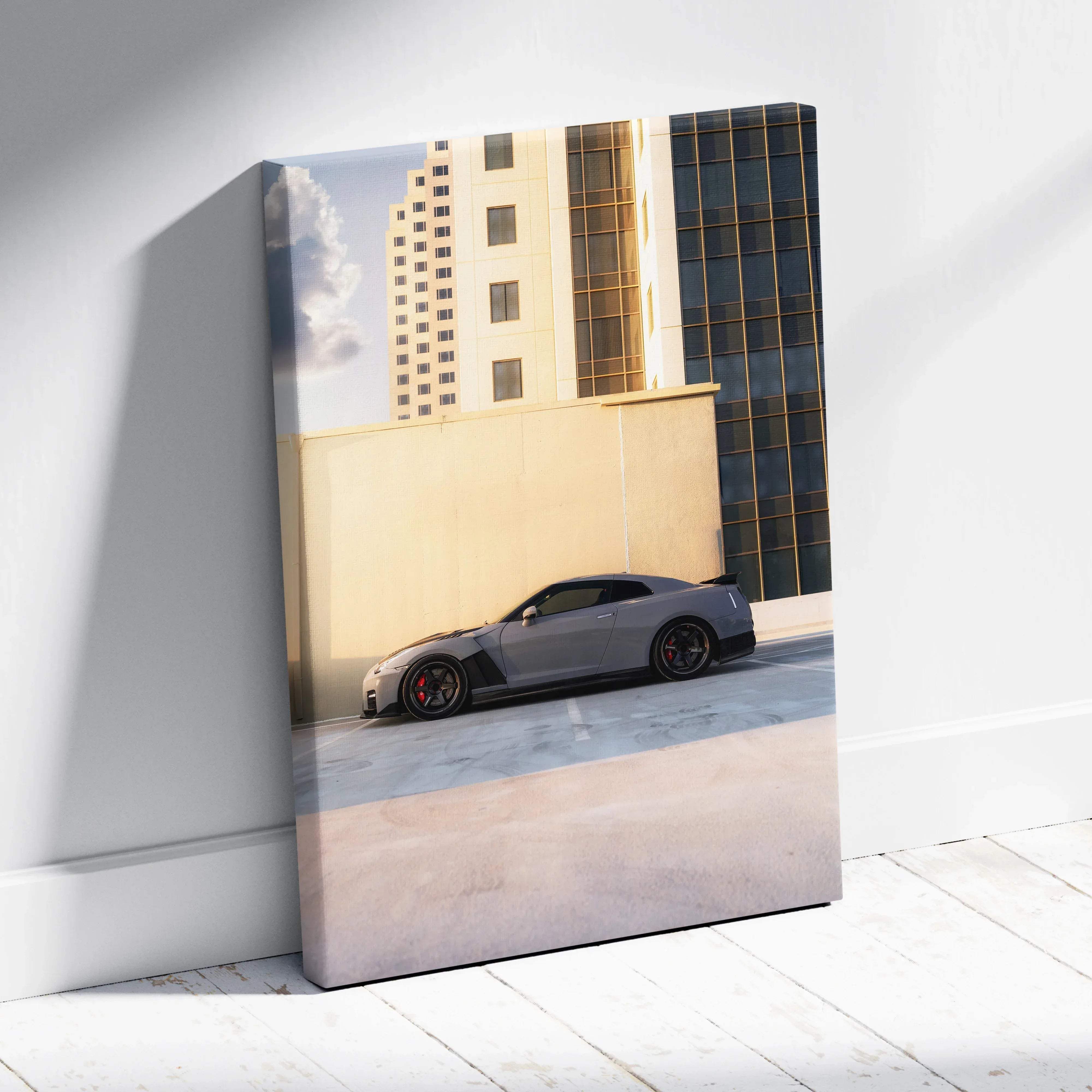 Canvas wall art of gray Nissan R35 GT-R with black rims and red brake calipers in sleek urban cityscape mood