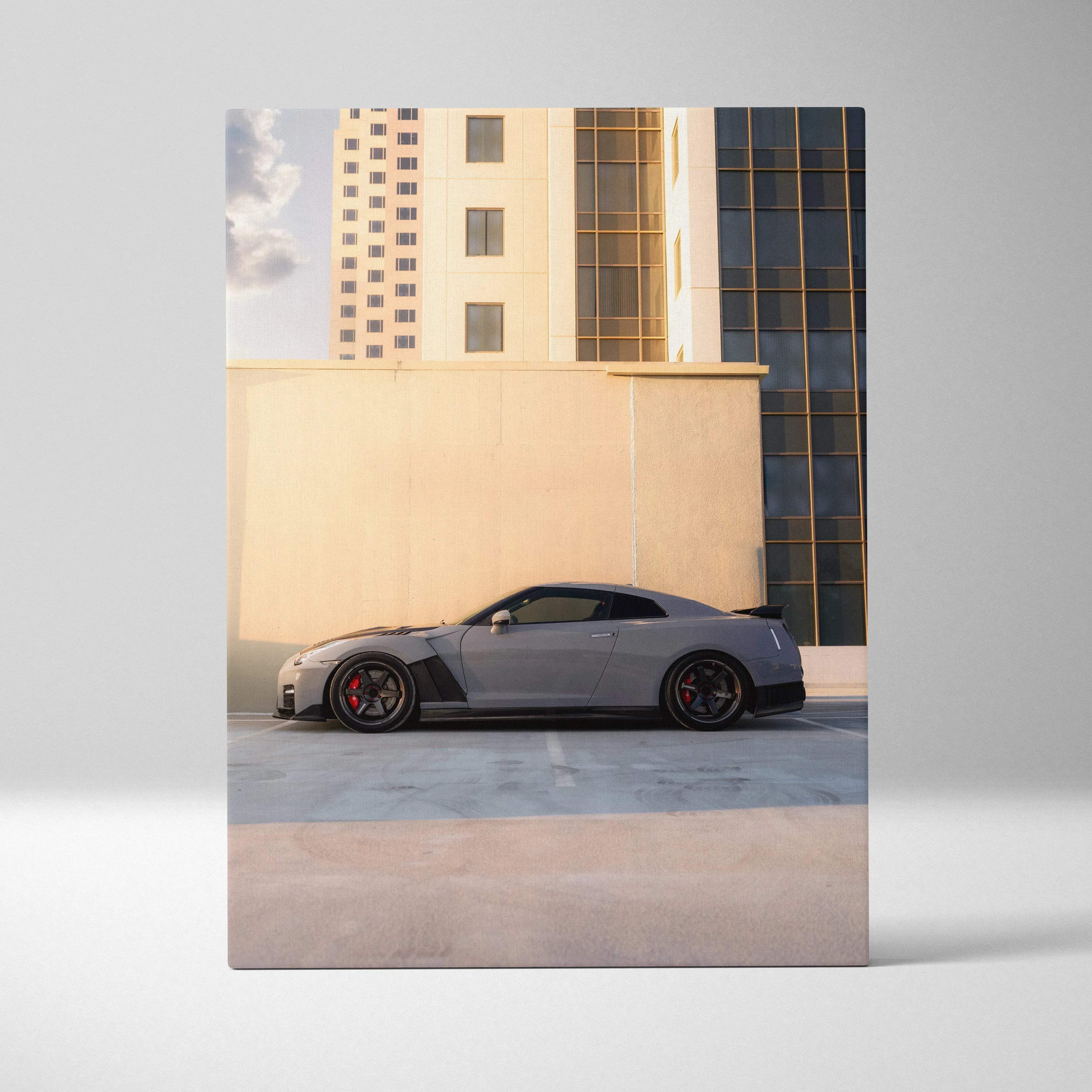 Canvas wall art featuring a sleek gray Nissan R35 GTR sports car with black accents and red brake calipers in urban cityscape
