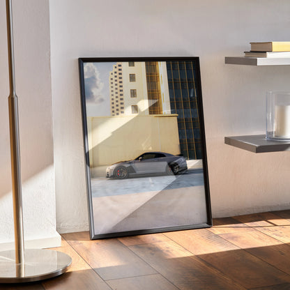 Nissan GTR R35 poster leaning on wall showcasing sleek sports car with city building background stylish wall art.