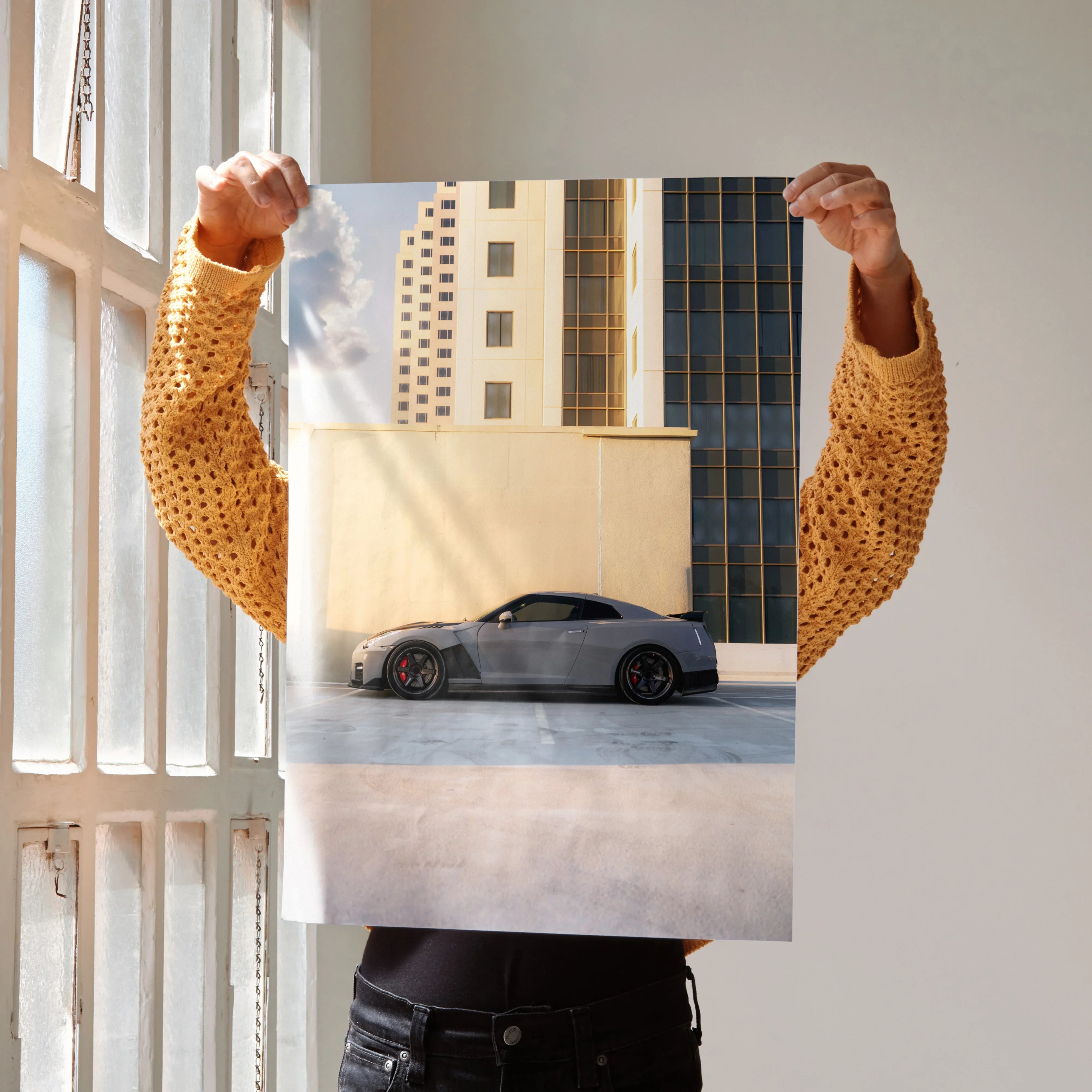 Nissan GTR R35 parked against urban building backdrop poster wall art with modern cityscape.