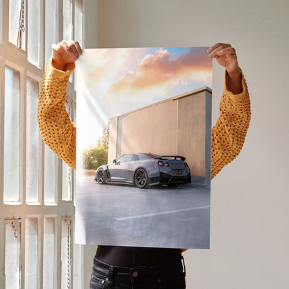 Nissan GTR R35 poster with gray car parked by modern building under pink sunset sky, wall art.