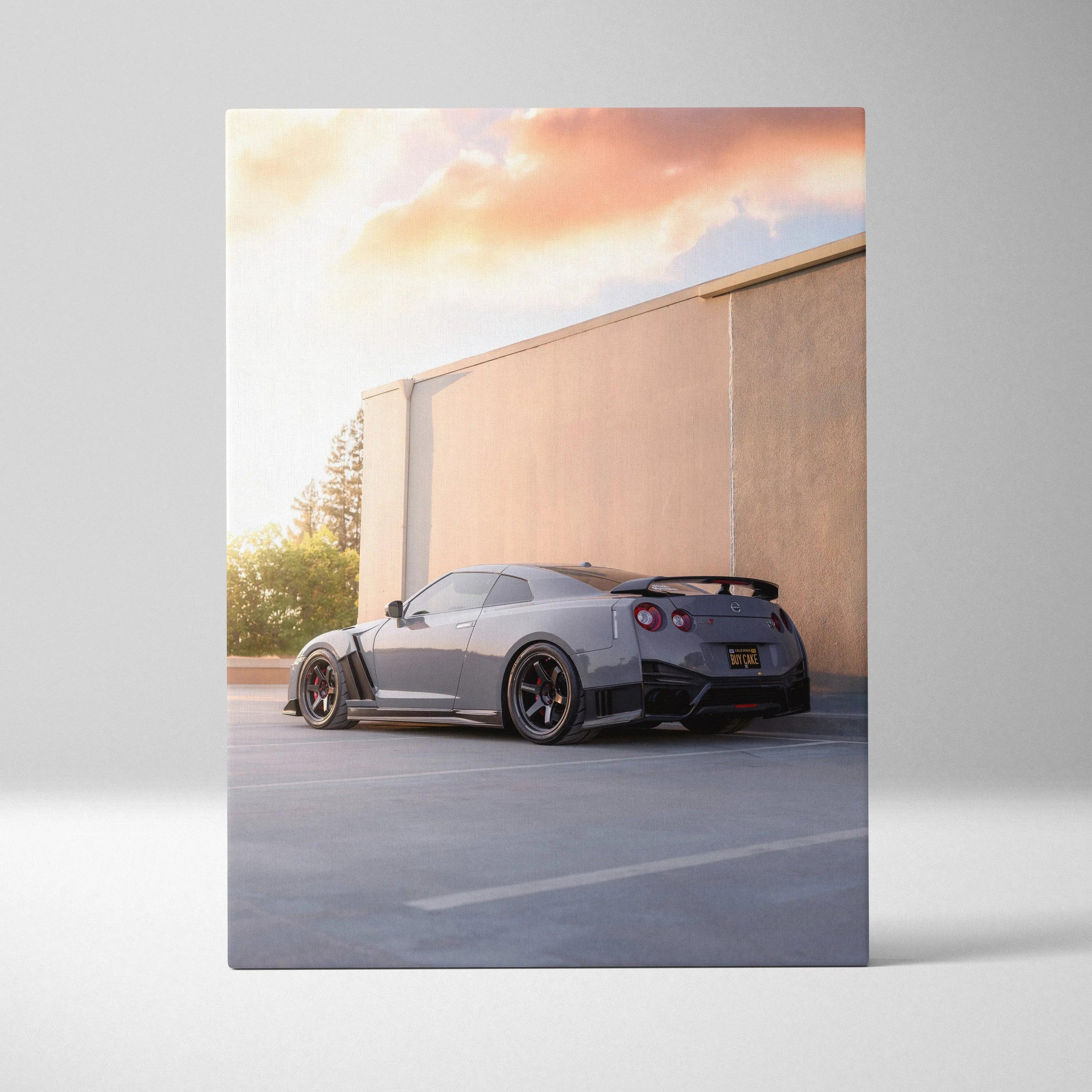 Nissan GTR R35 parked by a beige wall at sunset on vertical canvas wall art.