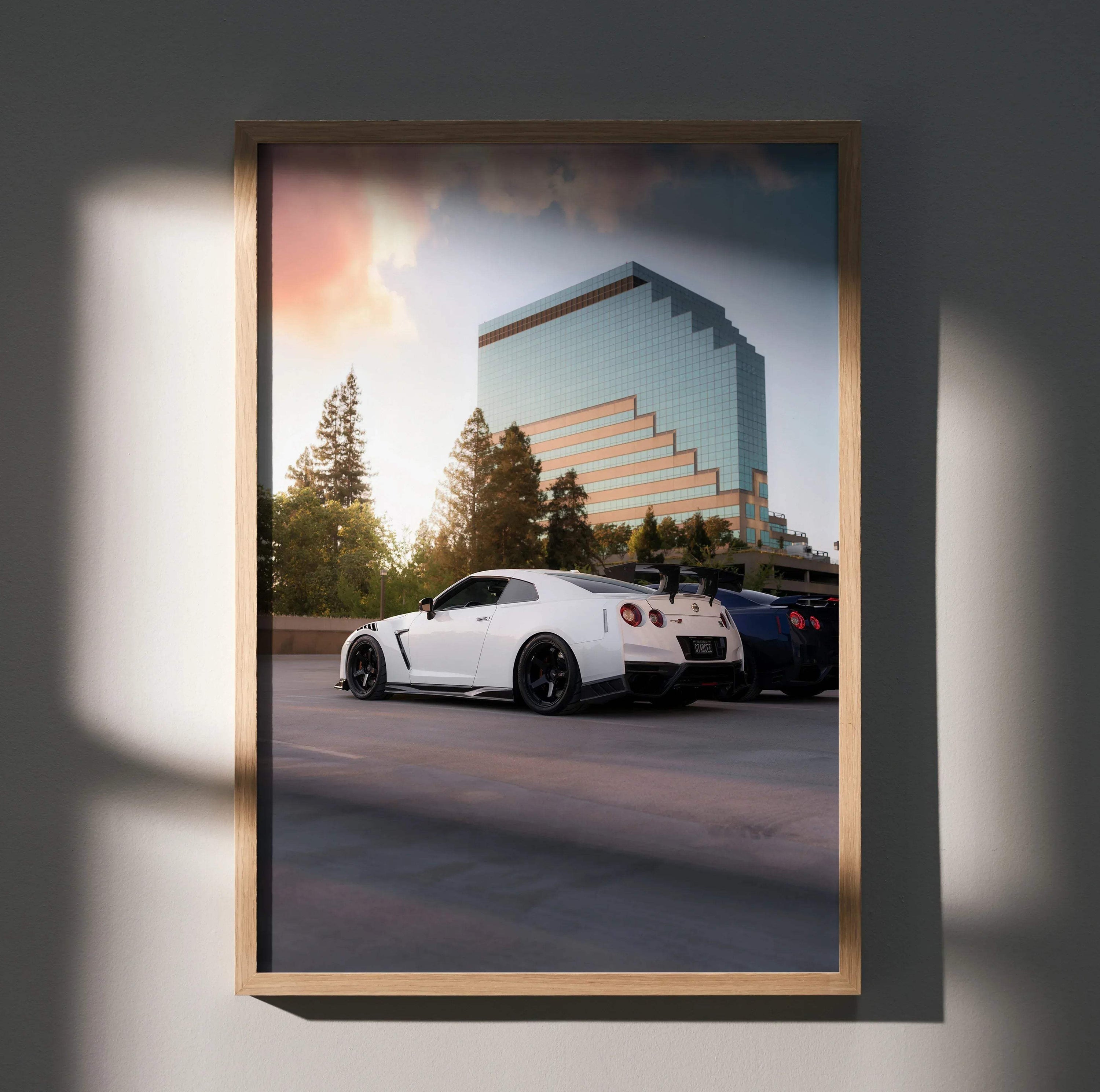Nissan GTR R35 white sports car parked at sunset with modern building backdrop poster wall art.