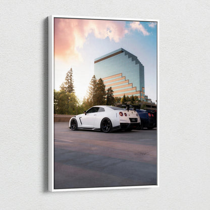 Vertical canvas wall art featuring a white Nissan R35 GTR parked against a sunset sky and modern glass building background.