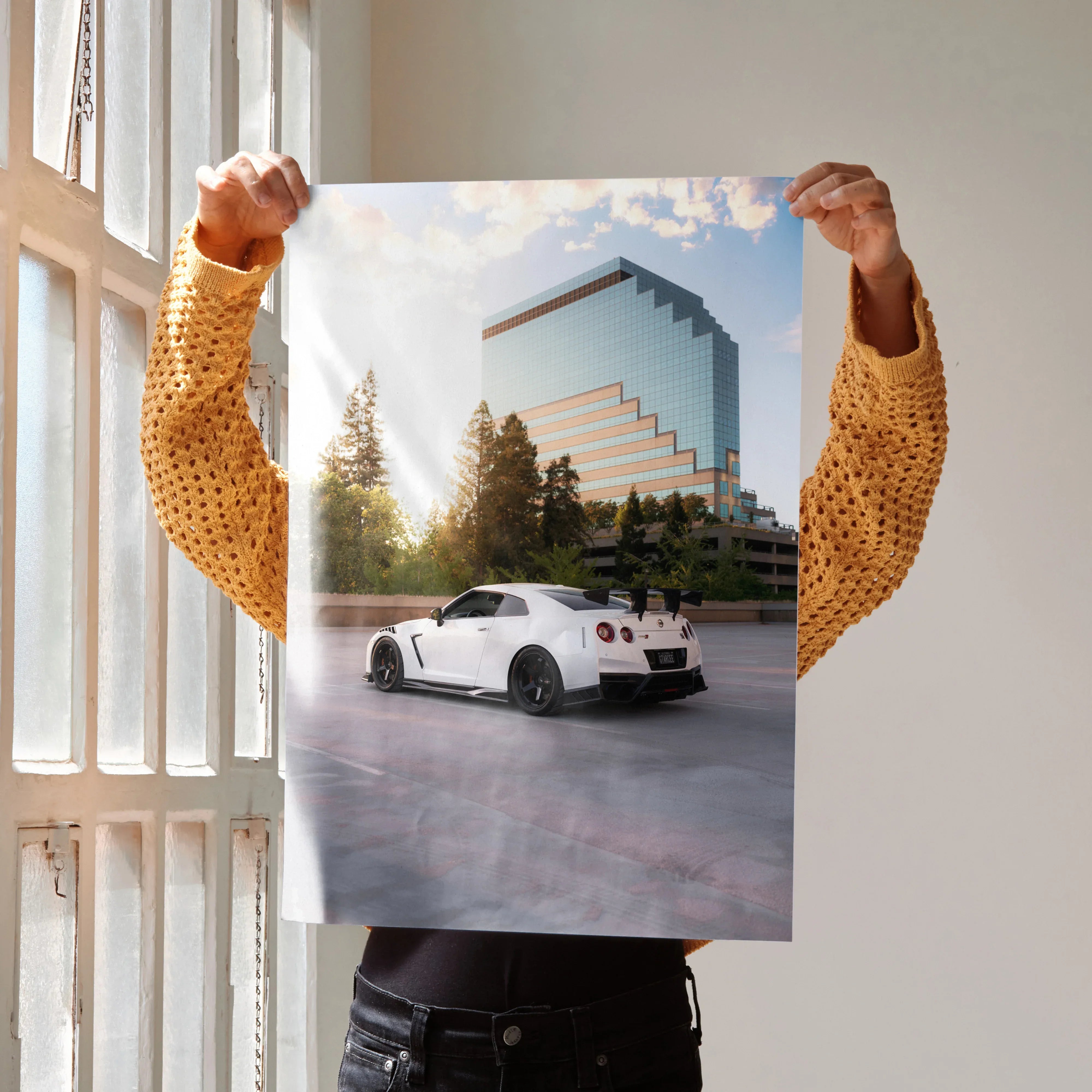Nissan GTR R35 parked in front of modern building with trees poster wall art.