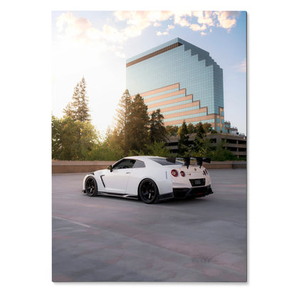 Nissan GTR R35 white sports car parked against modern glass building wall art poster.