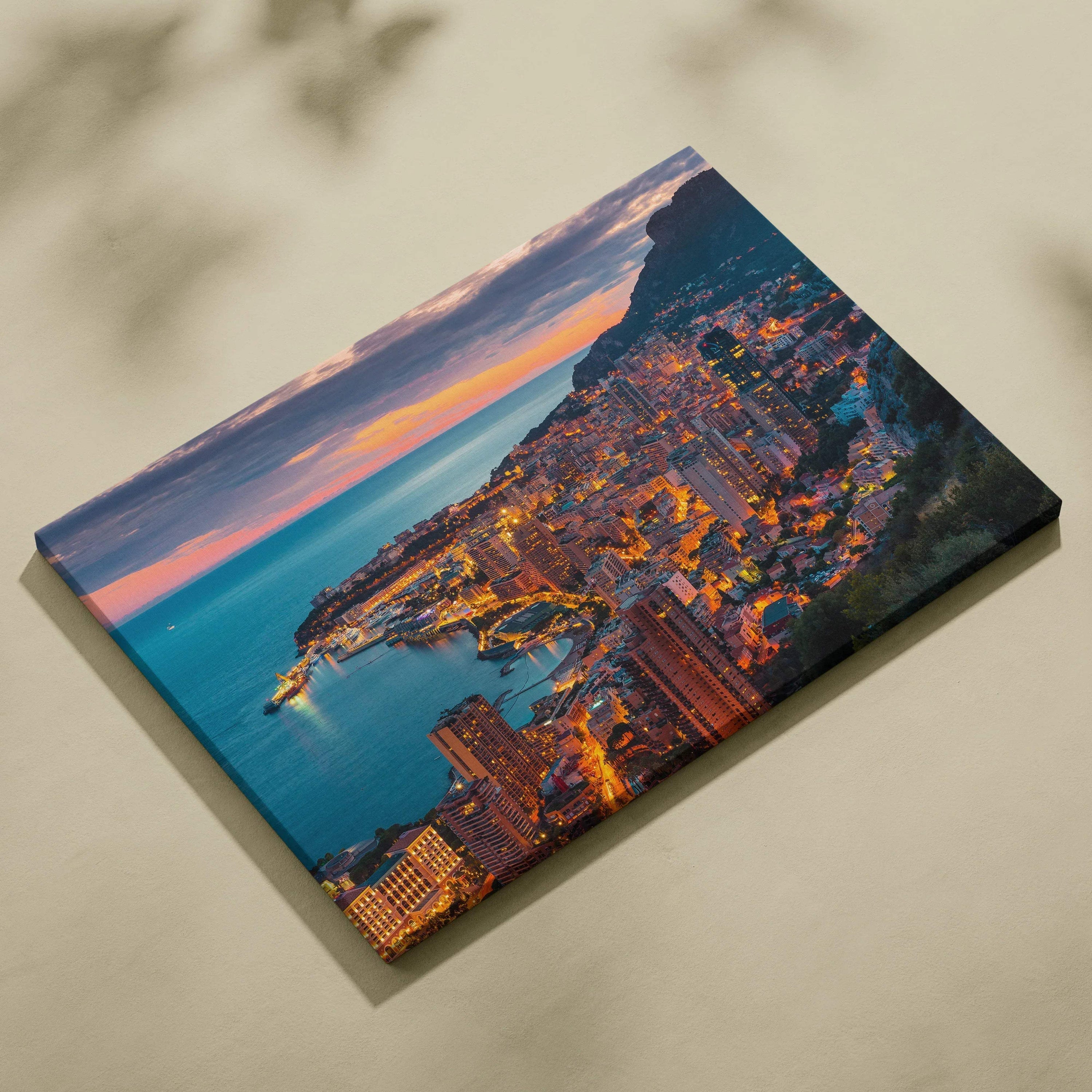 Canvas wall art featuring a vibrant cityscape with illuminated buildings at dusk and a nearby coastline.