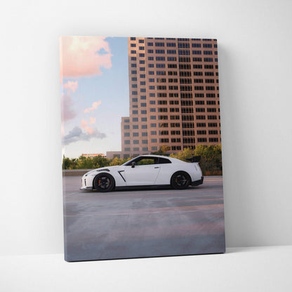 Nissan GTR R35 white car against sunset city skyline vertical canvas wall art.
