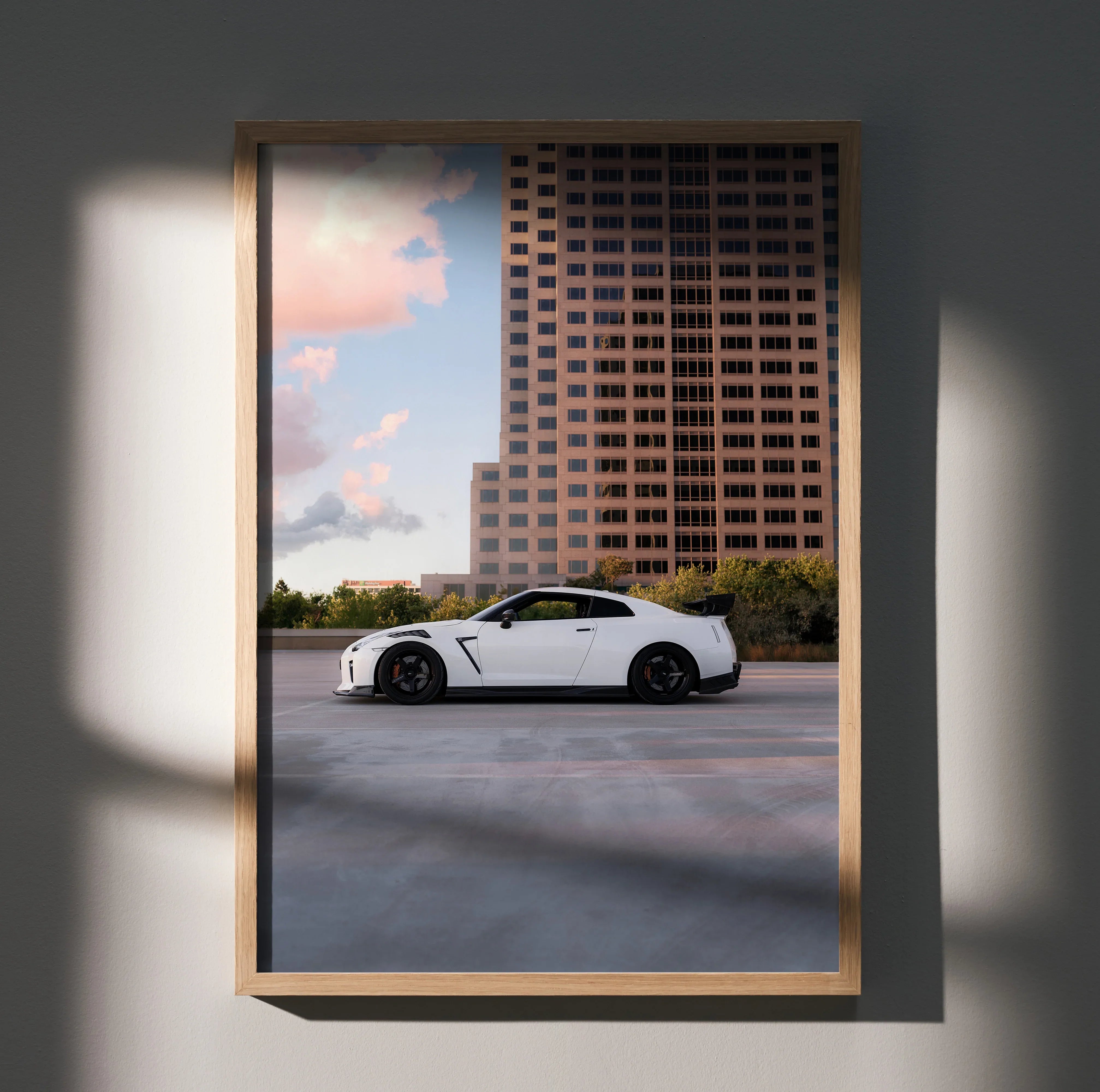 Nissan GTR R35 white sports car parked with cityscape background poster wall art.
