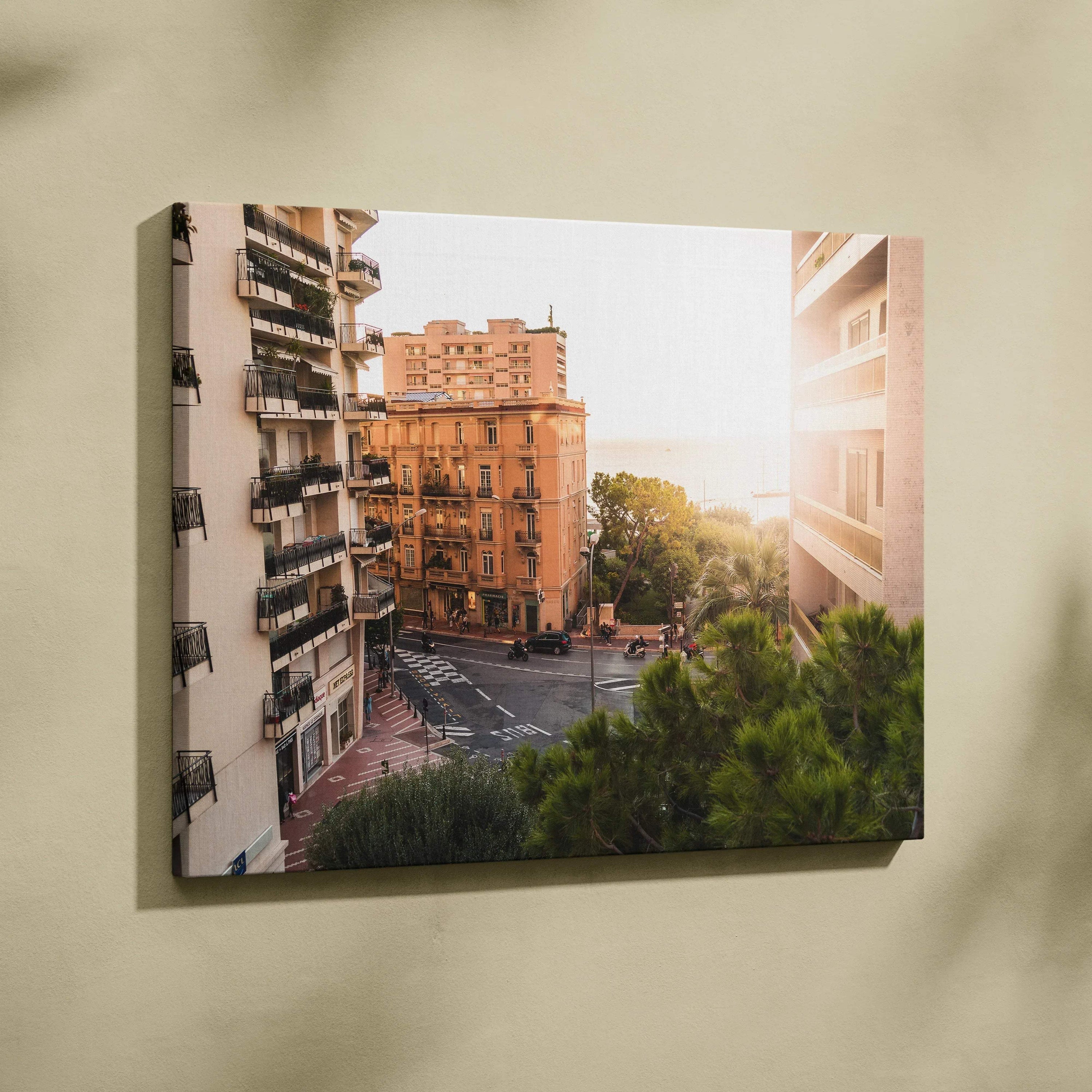 Canvas wall art featuring sunlit urban architecture with warm-toned buildings and greenery.