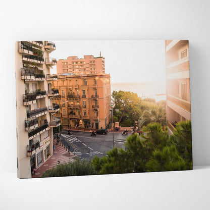Canvas wall art featuring a sunlit urban street scene with multi-story apartment buildings in warm tones.