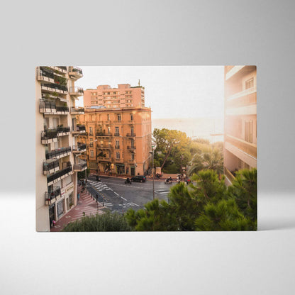 Canvas wall art featuring warm-toned urban buildings and lush greenery at sunset with soft lighting.