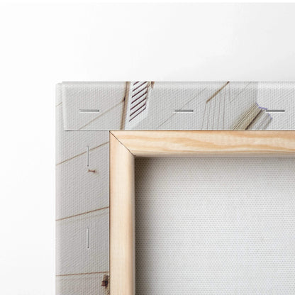 Close-up of wooden frame corner on white textured canvas wall art with architectural digital print.