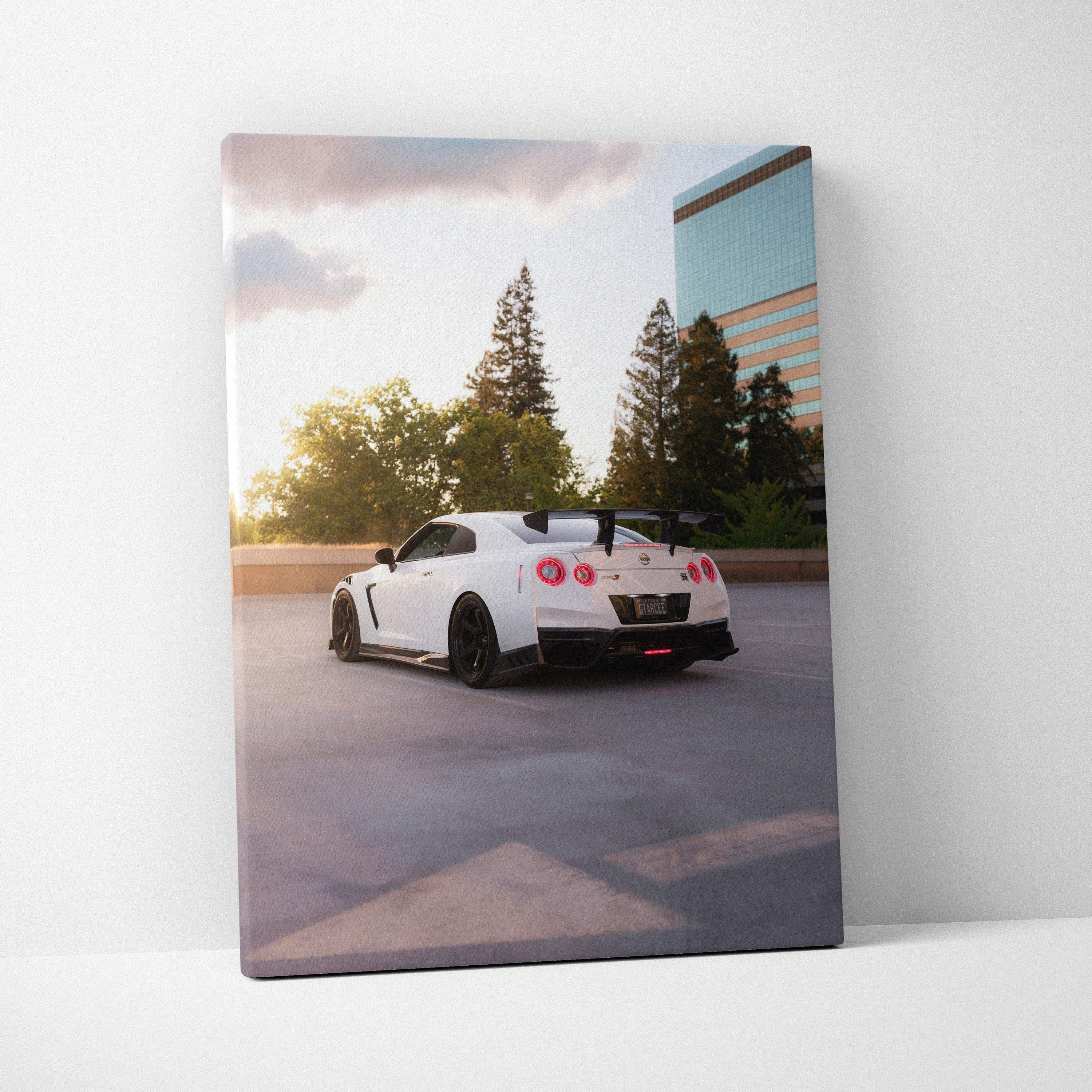 White Nissan R35 GTR at sunset on vertical canvas wall art with urban background.