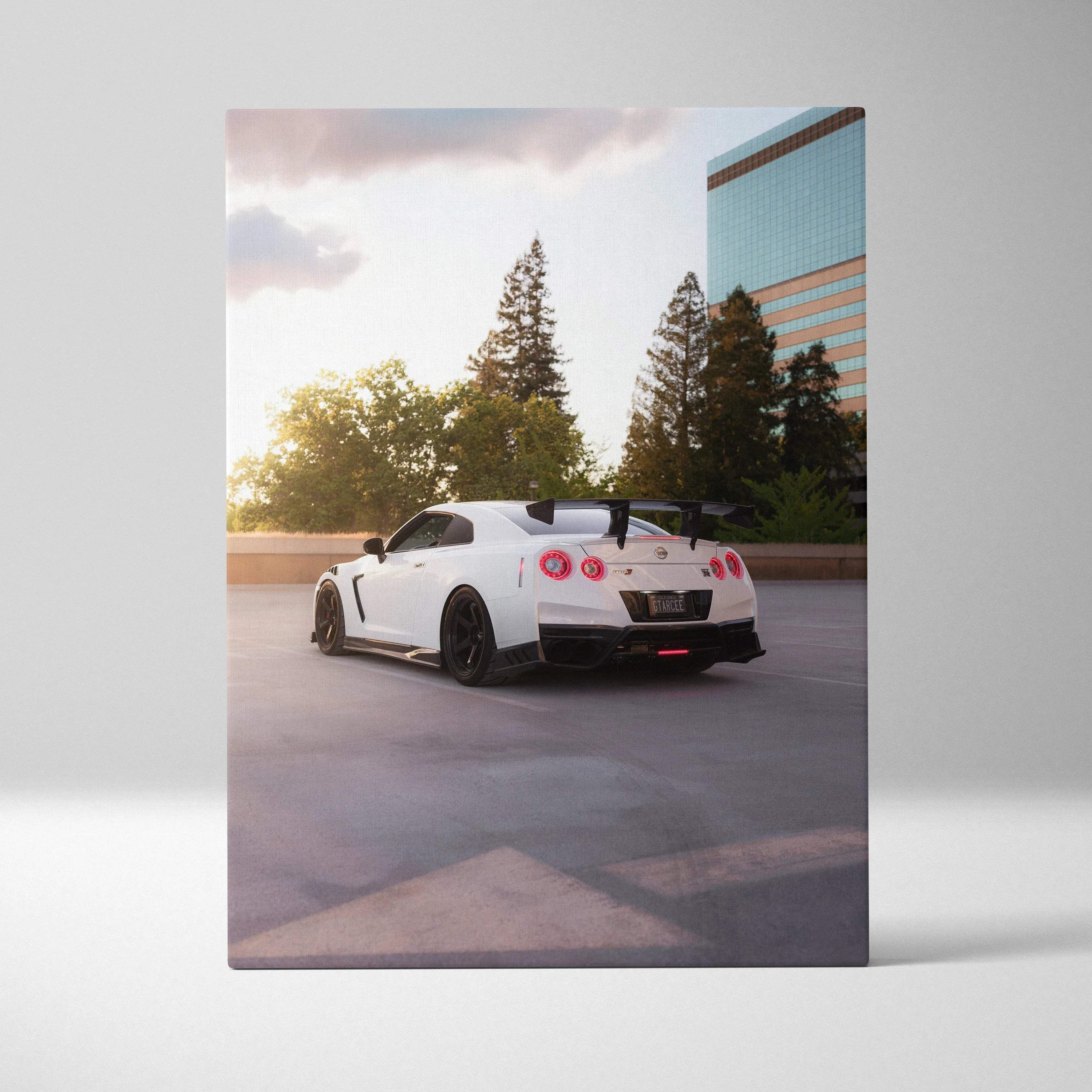 White Nissan GTR R35 at sunset on canvas wall art with urban background and soft lighting.