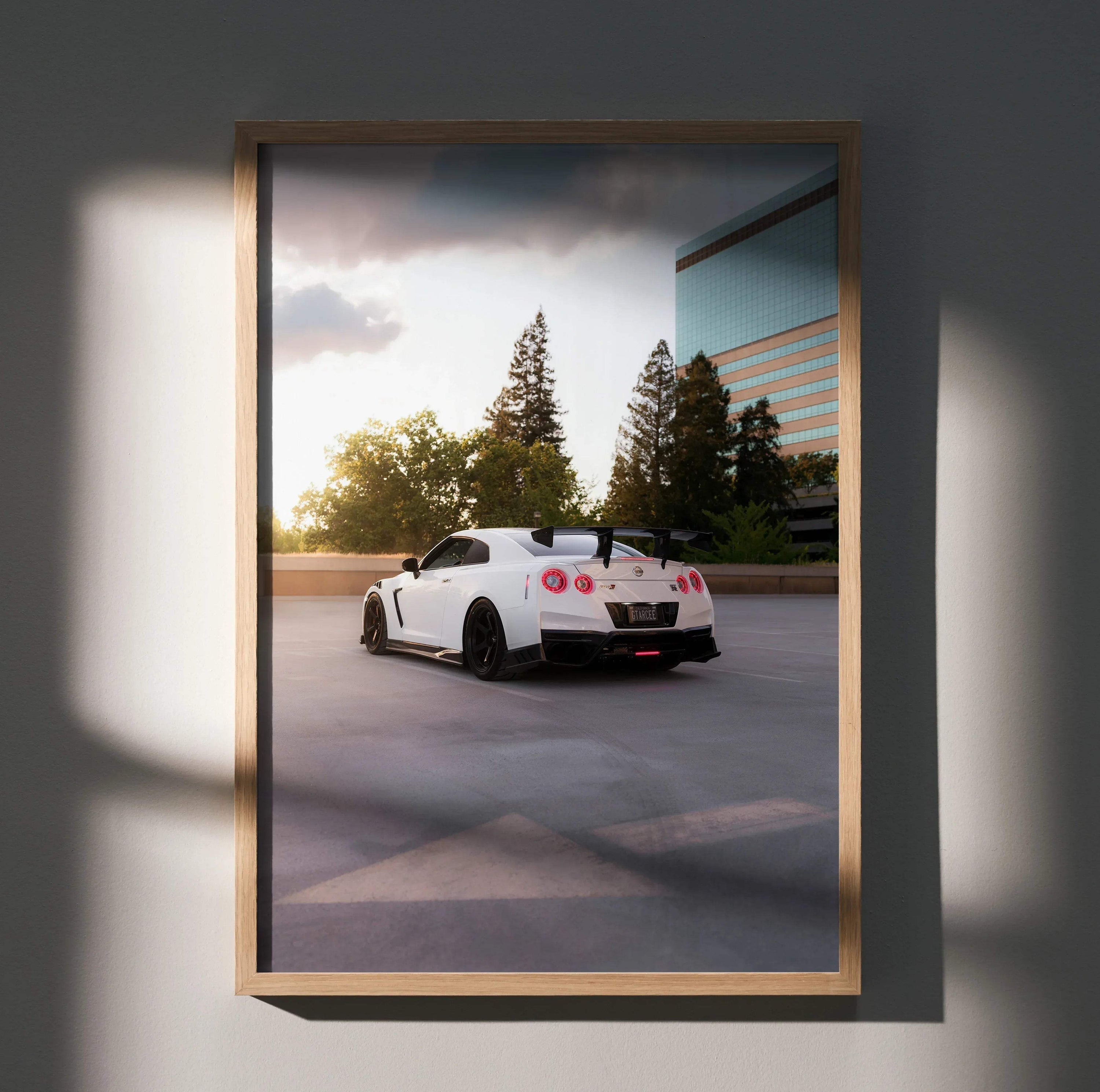 White Nissan GTR R35 parked near trees and building at sunset poster wall art.