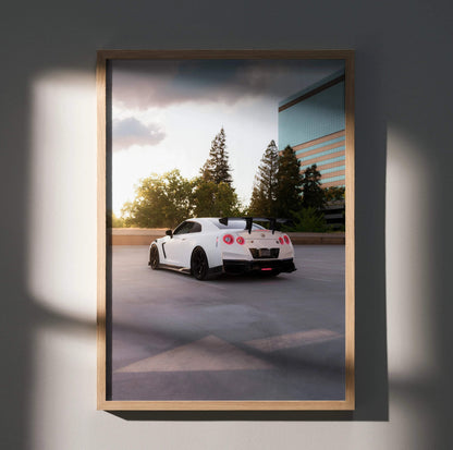 White Nissan GTR R35 parked near trees and building at sunset poster wall art.