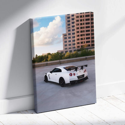 Vertical canvas art of white Nissan R35 GTR on rooftop with city skyline and blue sky background.