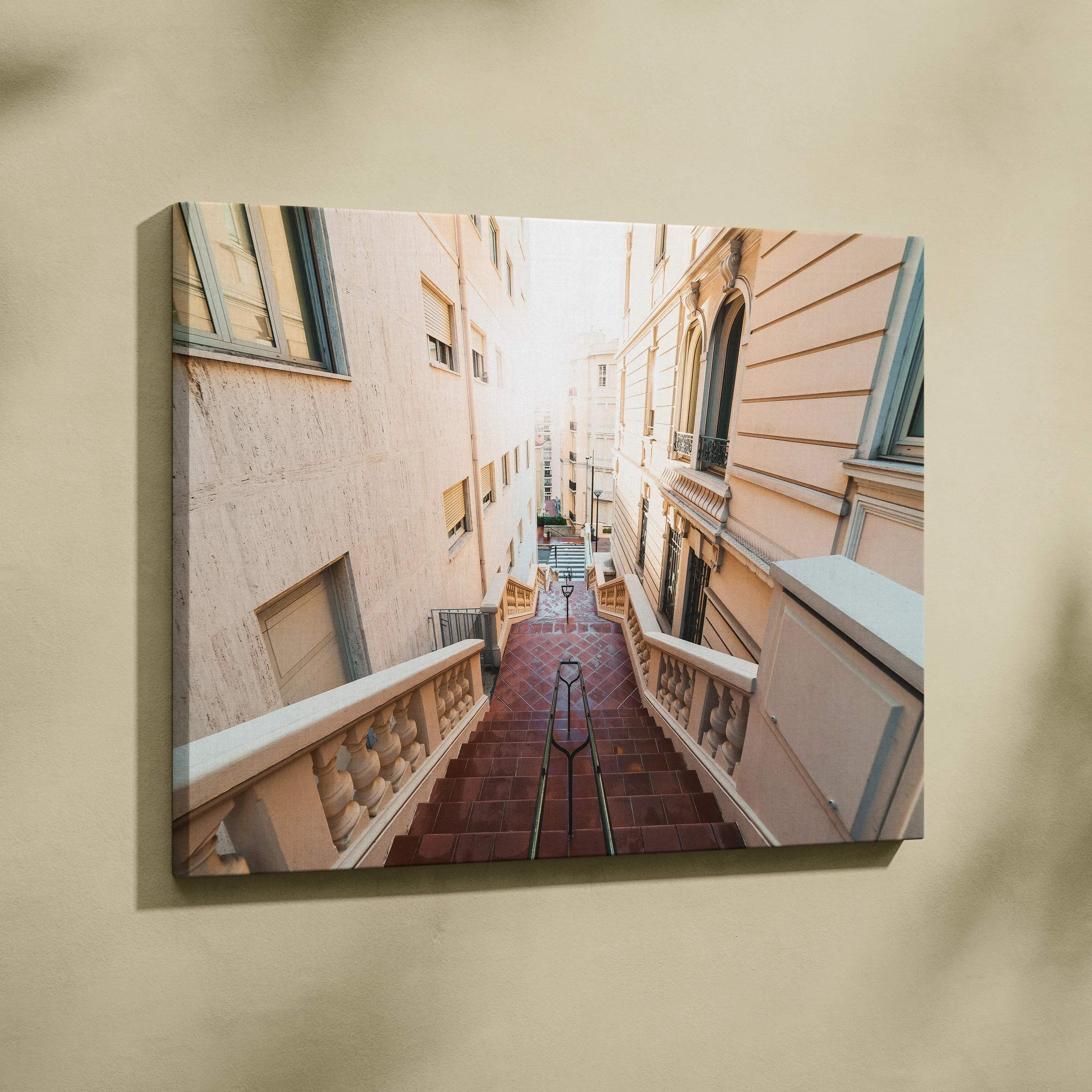 Canvas wall art featuring a sunlit narrow alley with stairway and buildings in soft beige tones.