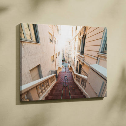Canvas wall art featuring a sunlit narrow alley with stairway and buildings in soft beige tones.