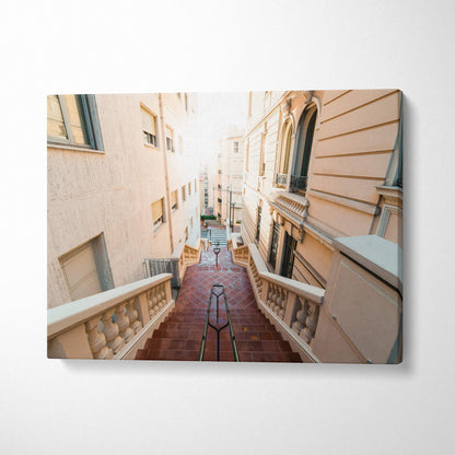 Canvas wall art of a sunlit narrow European-style street with stairs and beige buildings.