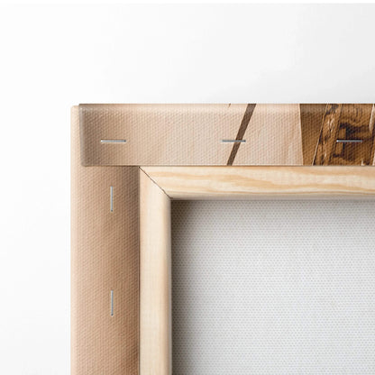 Close-up of beige stretched canvas corner with wooden frame and visible staples on white background.