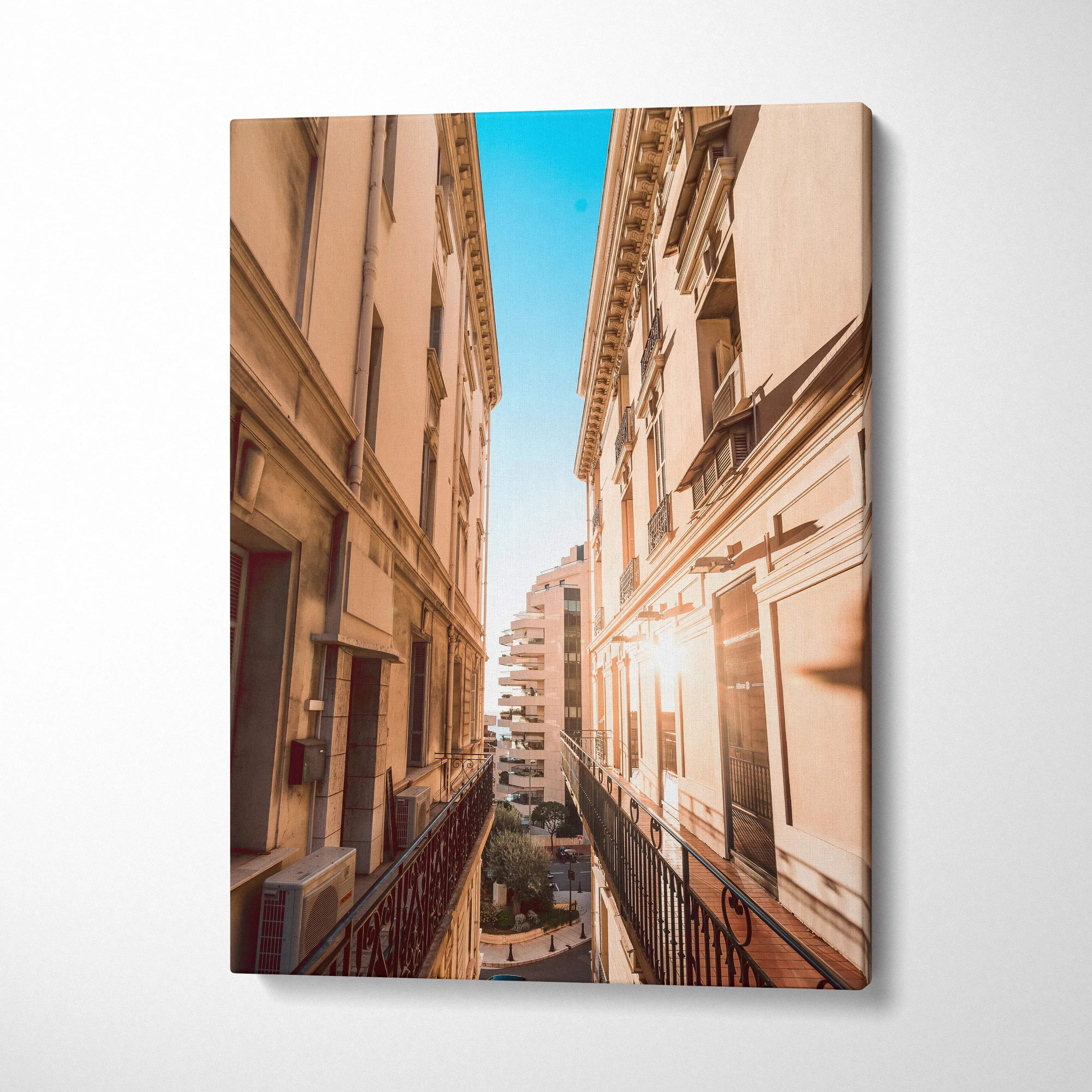 Vertical canvas wall art featuring high-resolution digital architecture of narrow European street and buildings under clear.