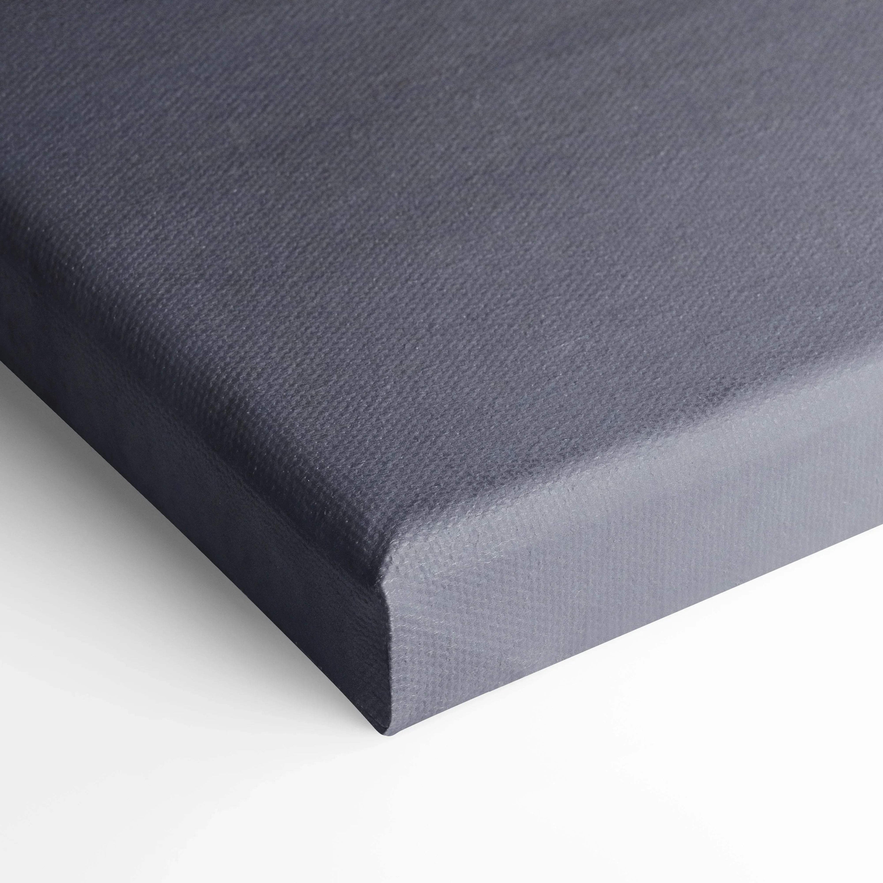 Gray textured canvas stretched over wooden frame, vertical wall art canvas print close-up.