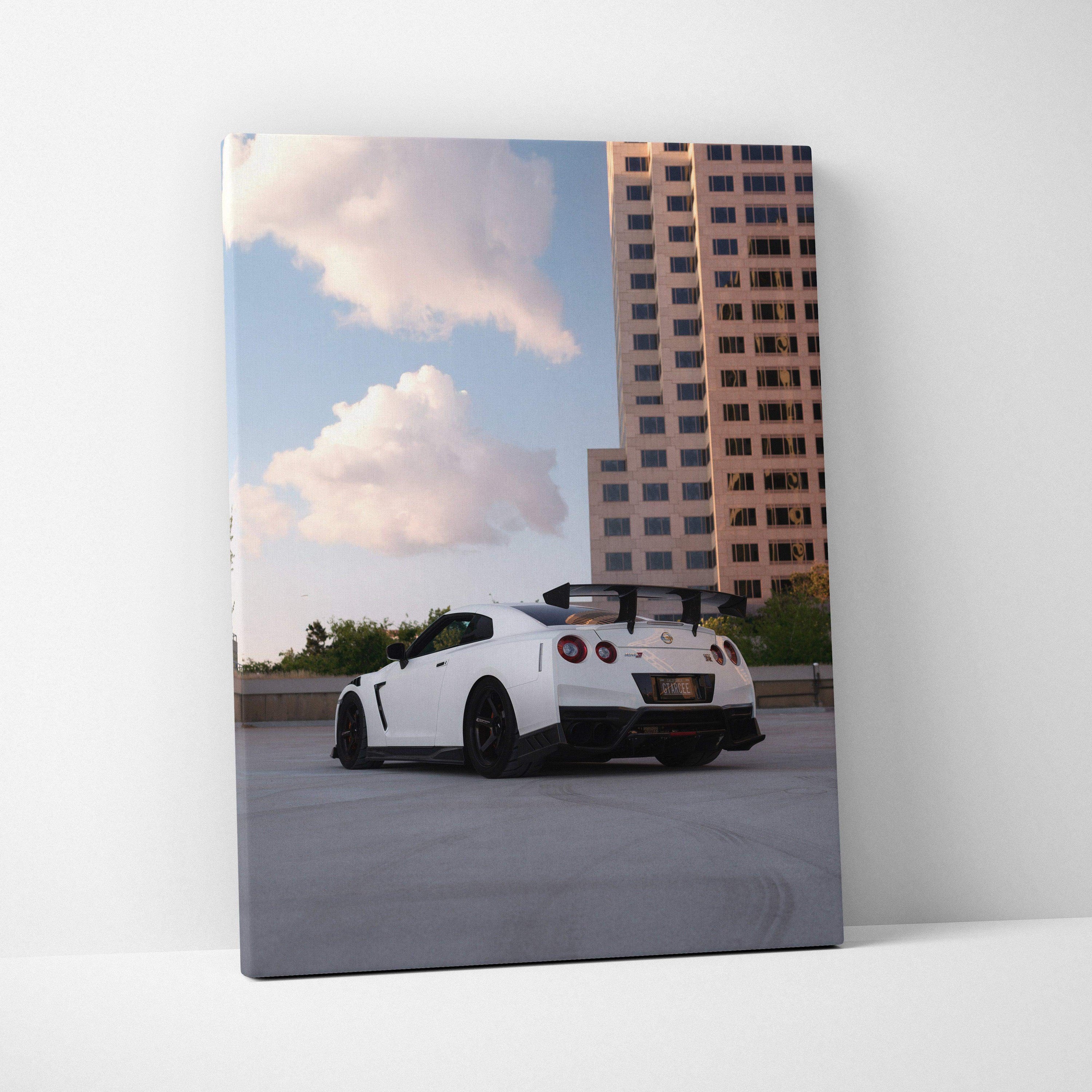 White Nissan GTR R35 parked under blue sky with clouds, vertical canvas art wall decor.