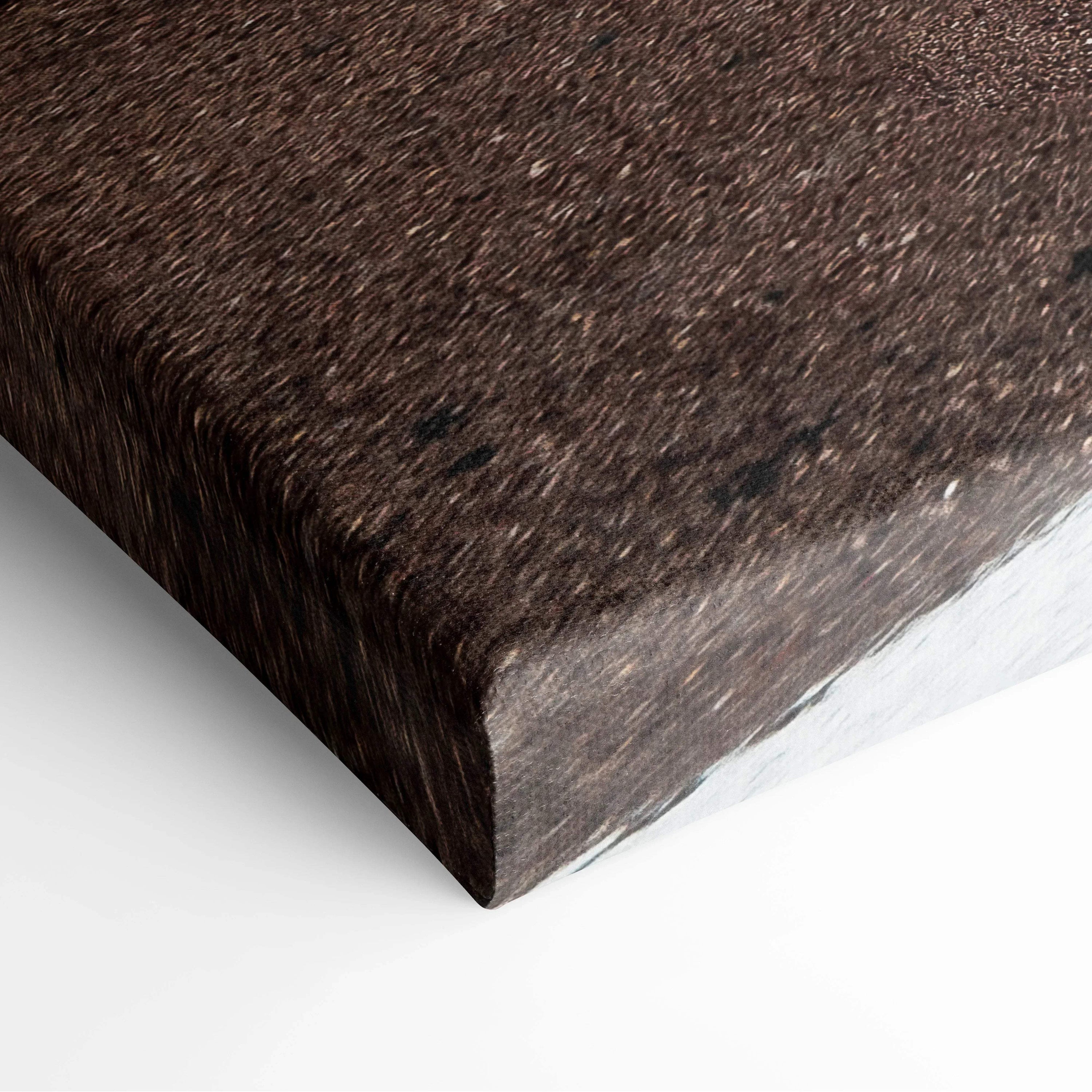 Close-up of a stretched canvas wall art corner with a dark brown textured design and sharp edges.