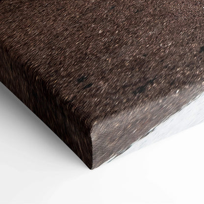 Close-up of a stretched canvas wall art corner with a dark brown textured design and sharp edges.