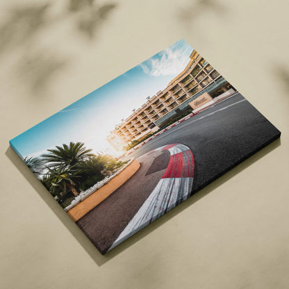 Canvas wall art featuring a vibrant F1 race track corner with red and white curbs, modern buildings, and palm trees under a.