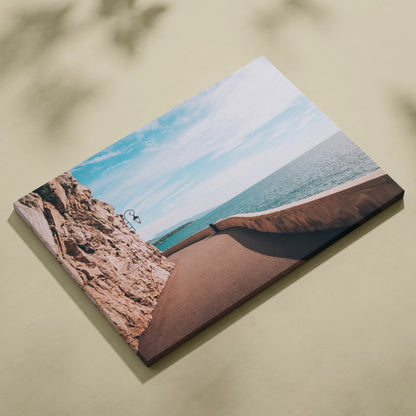 Canvas wall art featuring a digital ocean scene with rocky architecture and calm blue sky.