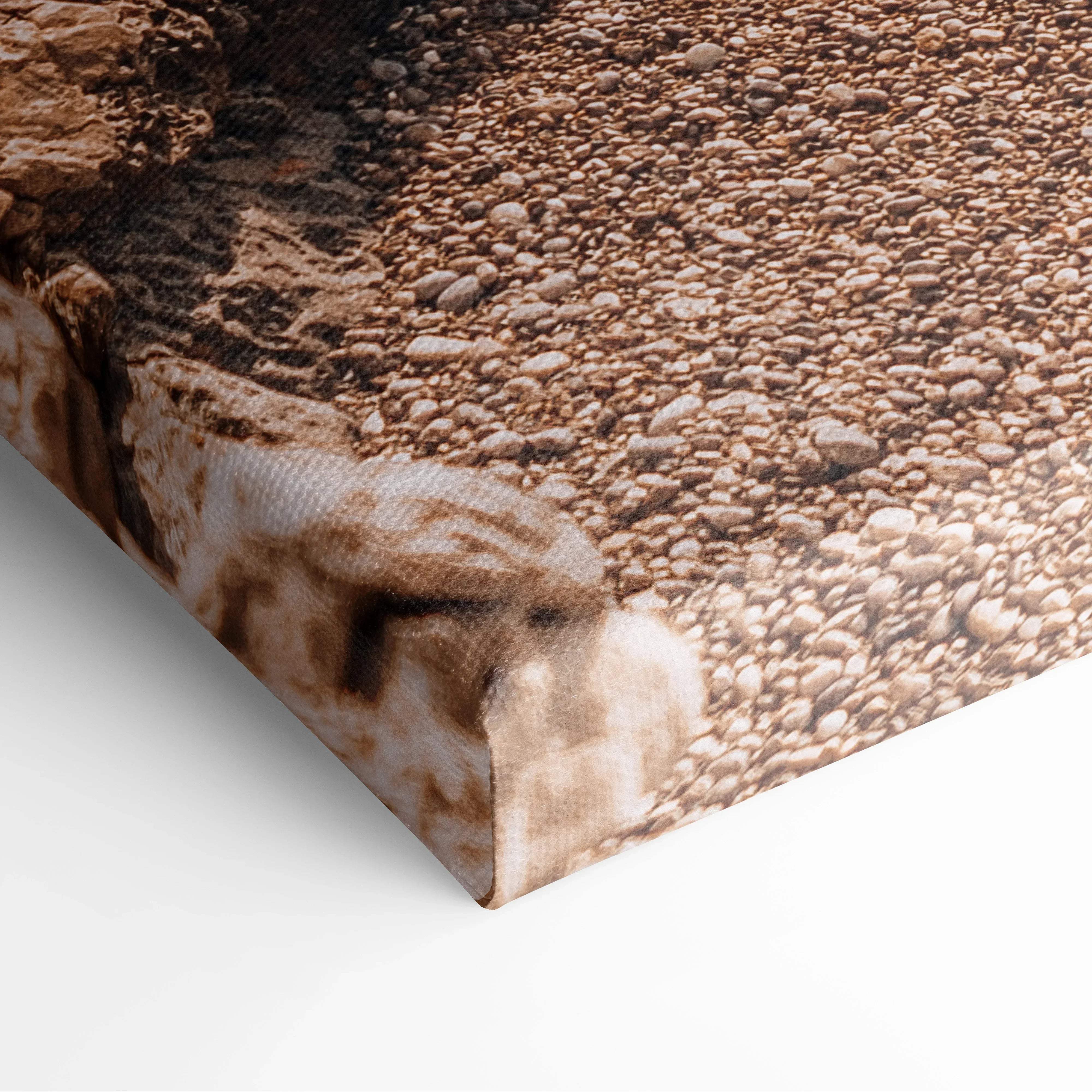 Canvas print of textured brown beige pebbles on turquoise ocean beach shoreline