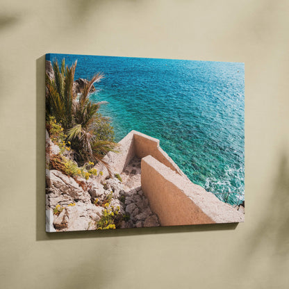 Canvas wall art featuring coastal architecture with beige stone stairs and vibrant blue ocean background.