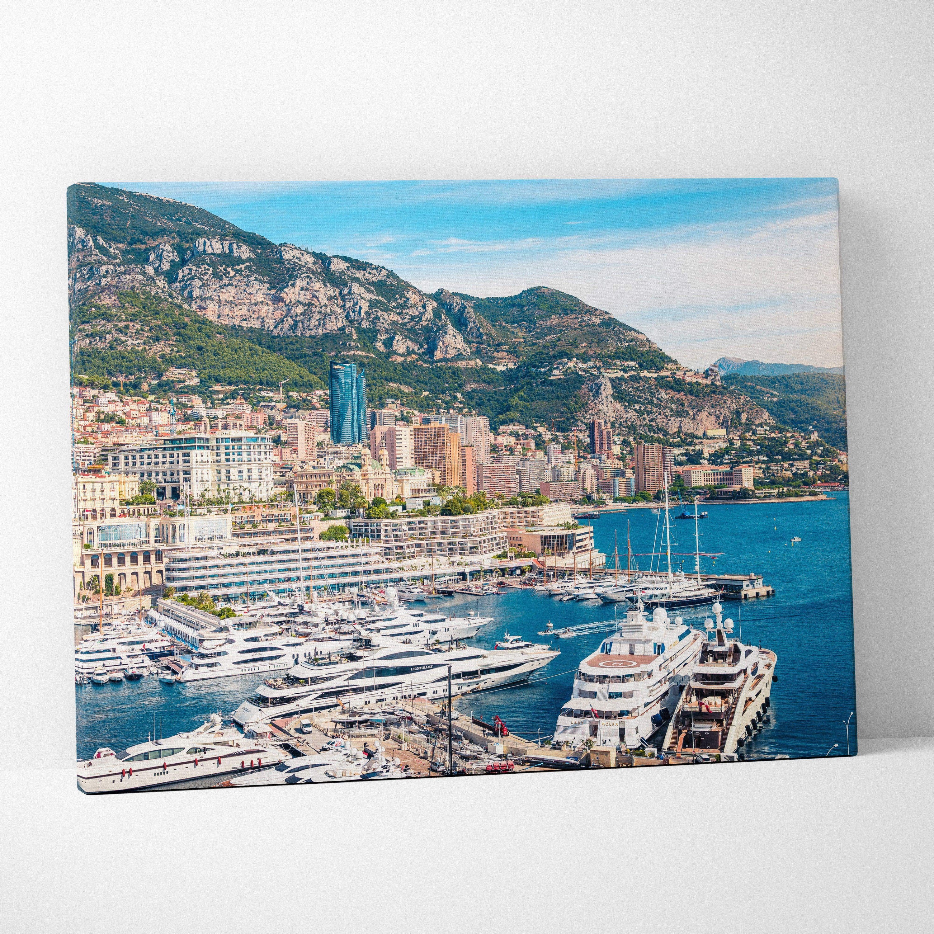 Canvas wall art featuring a vibrant coastal cityscape with yachts, buildings, and green hills under a bright blue sky.