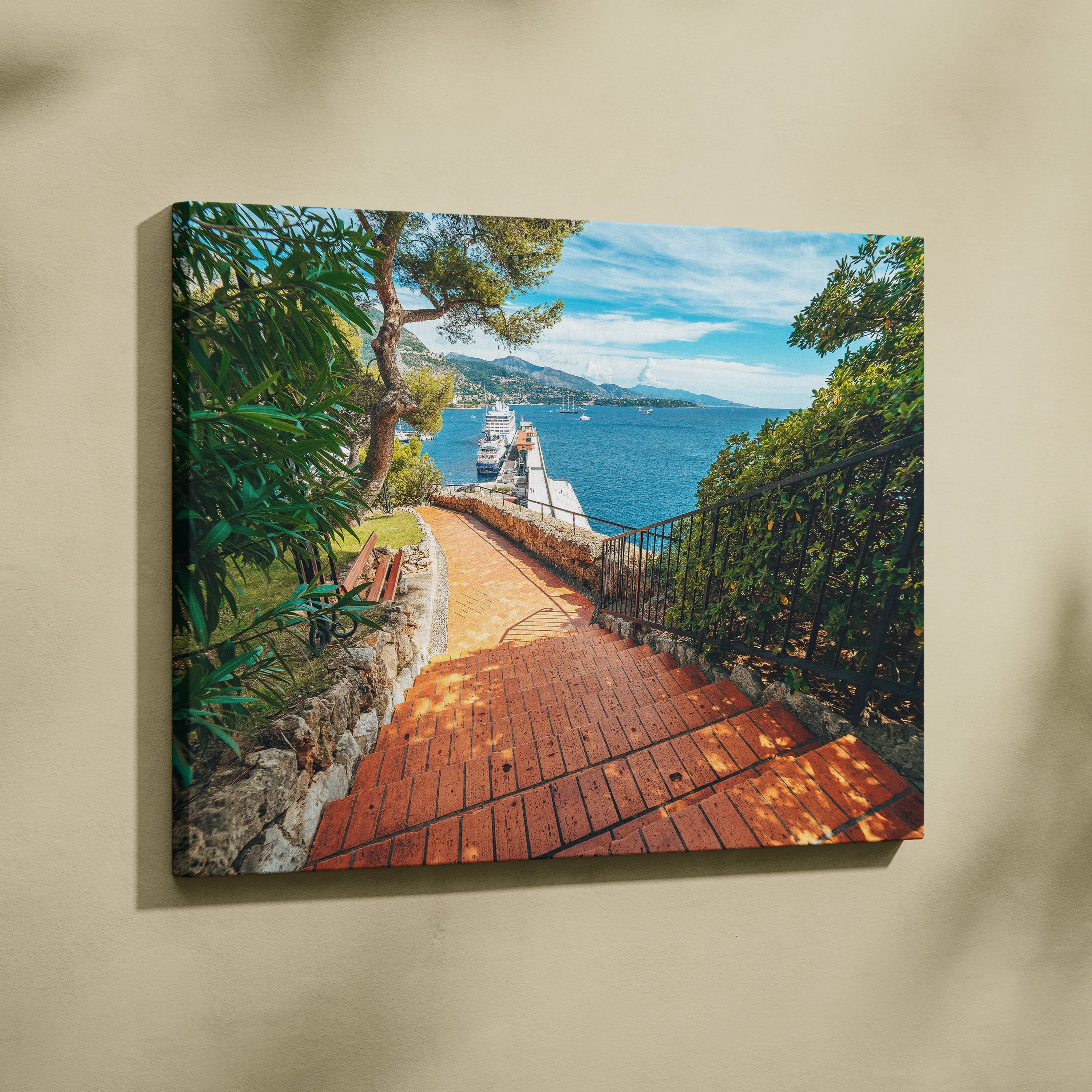 Beach pathway with brick walkway and lush greenery, vibrant canvas wall art with ocean view and buildings.