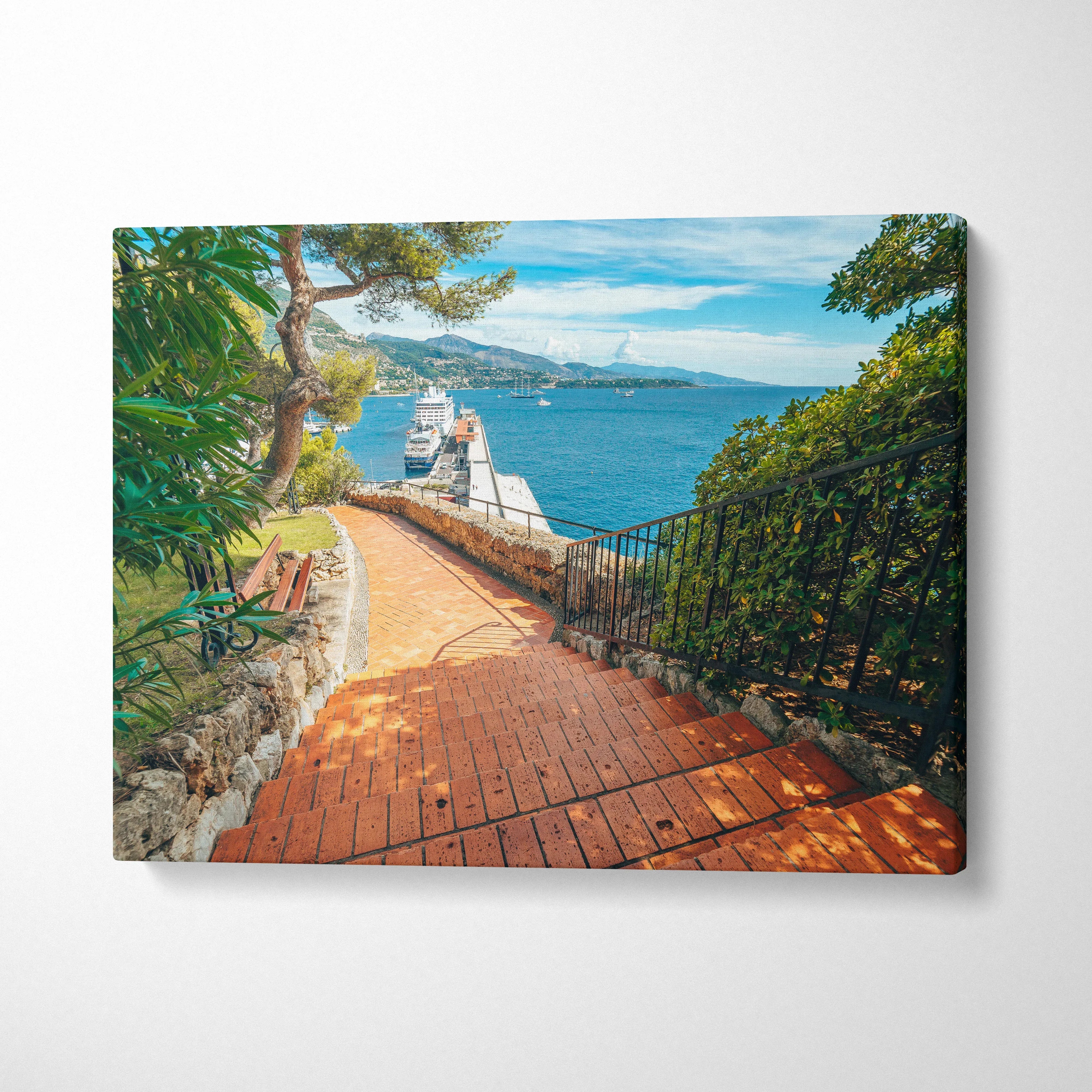 Beachside pathway with vibrant foliage and ocean view printed on canvas wall art.