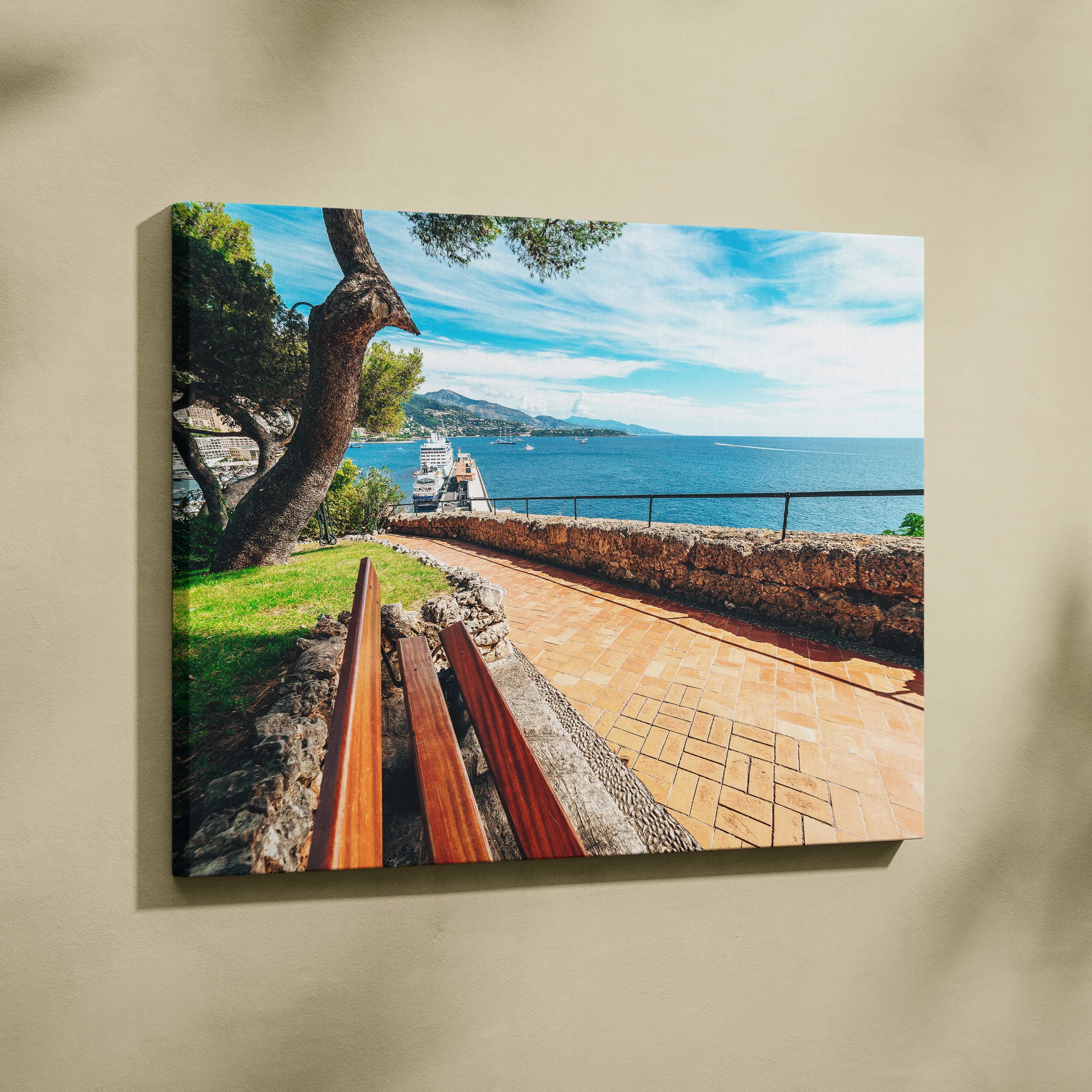 Canvas wall art of a sunny beachside walkway with wooden benches, stone walls, and blue ocean under a bright sky.