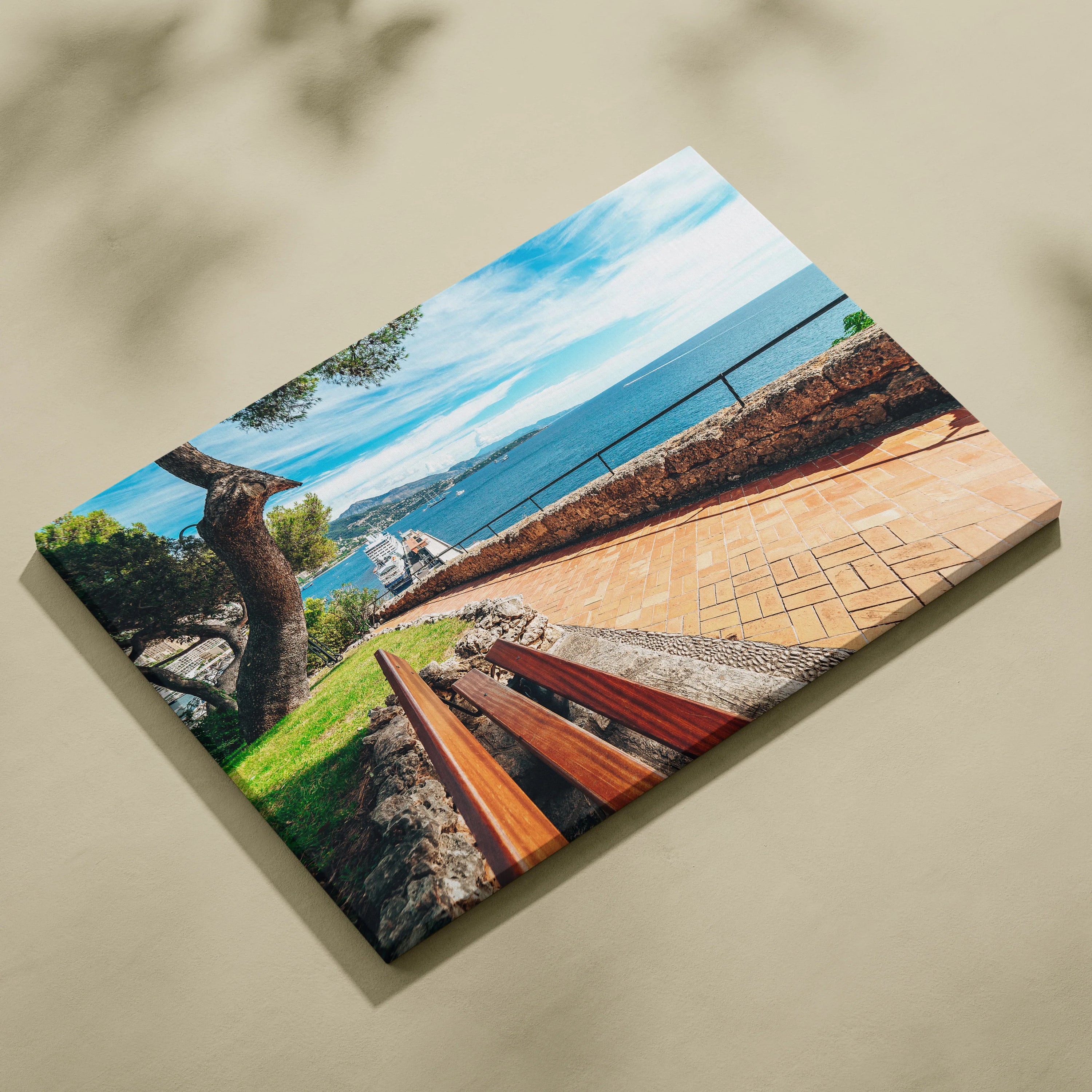 Vibrant beach scene canvas art featuring ocean view, walkway, tree, and modern buildings with bright blue sky.