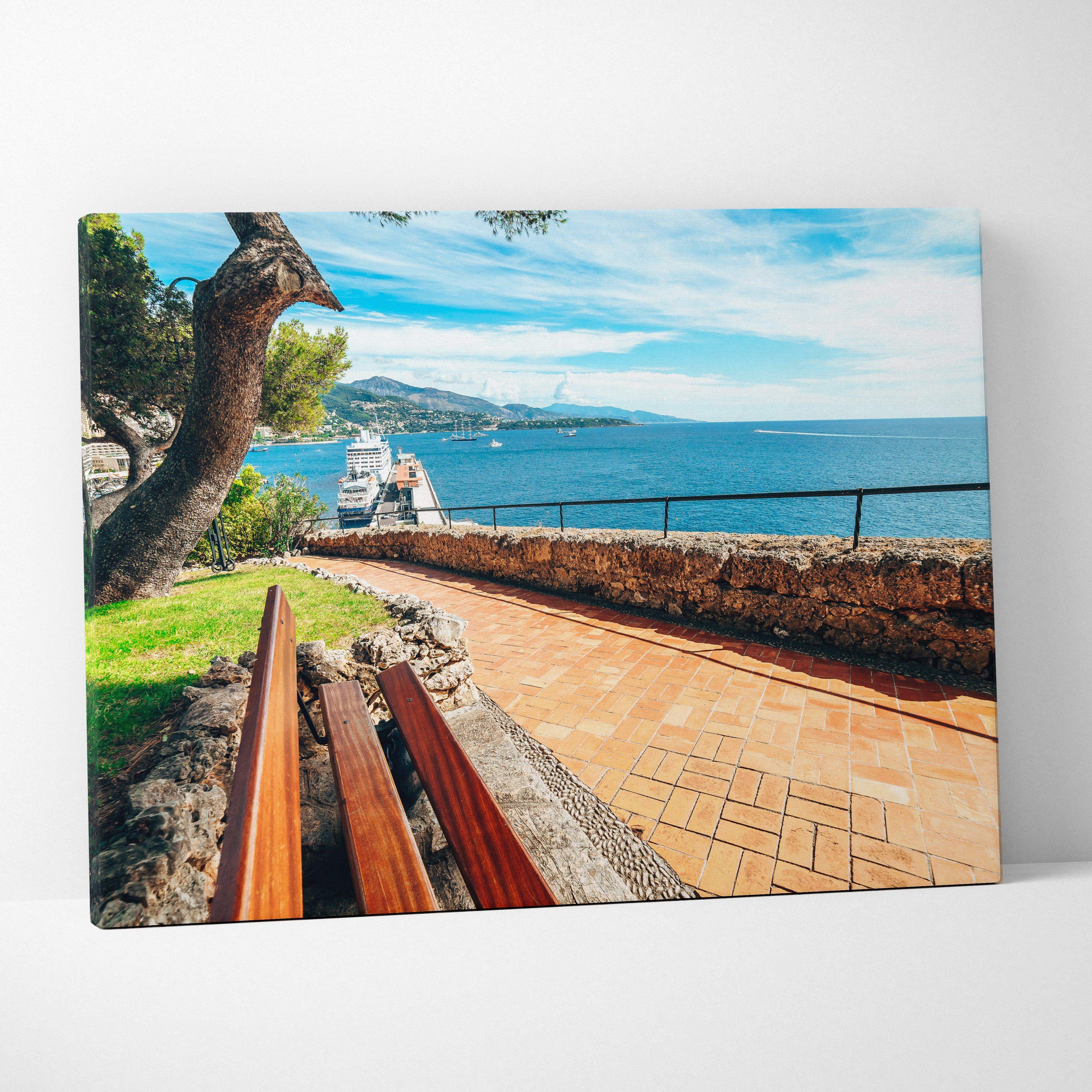 Coastal seaside promenade canvas wall art features a vibrant turquoise oceanfront scene with a winding stone path under a blue sky