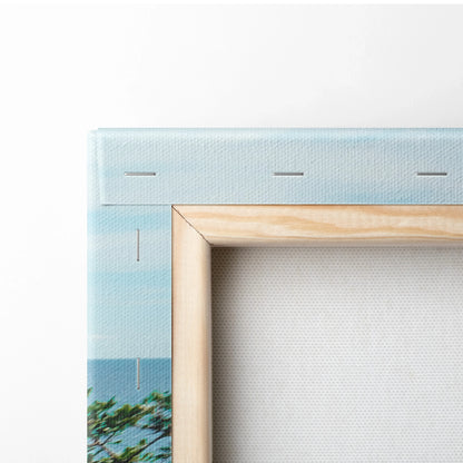 Close-up of wooden frame and textured canvas corner with subtle blue and green colors on wall art print.