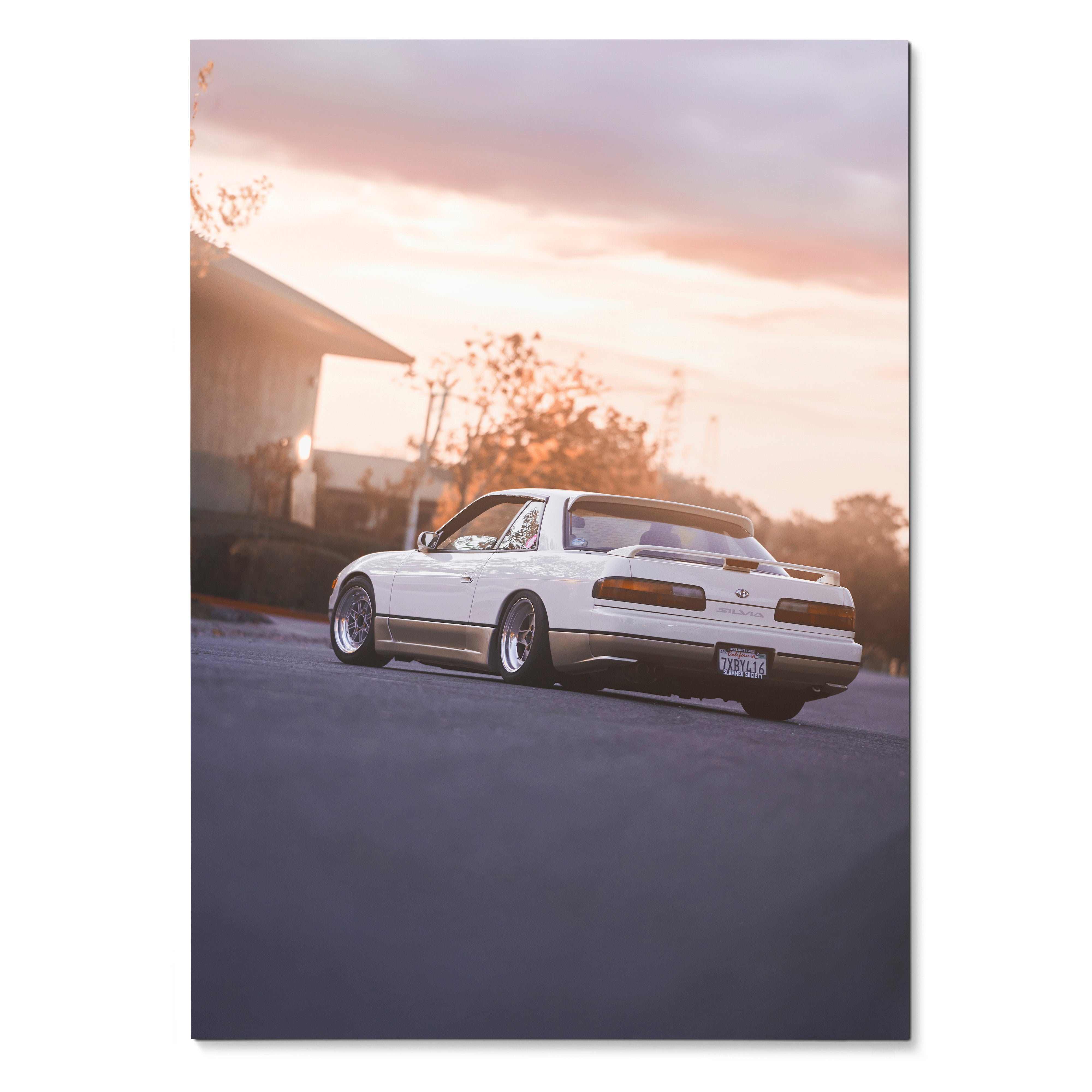 White Nissan 240sx S13 Silvia parked on street at sunset framed as automotive poster wall art.